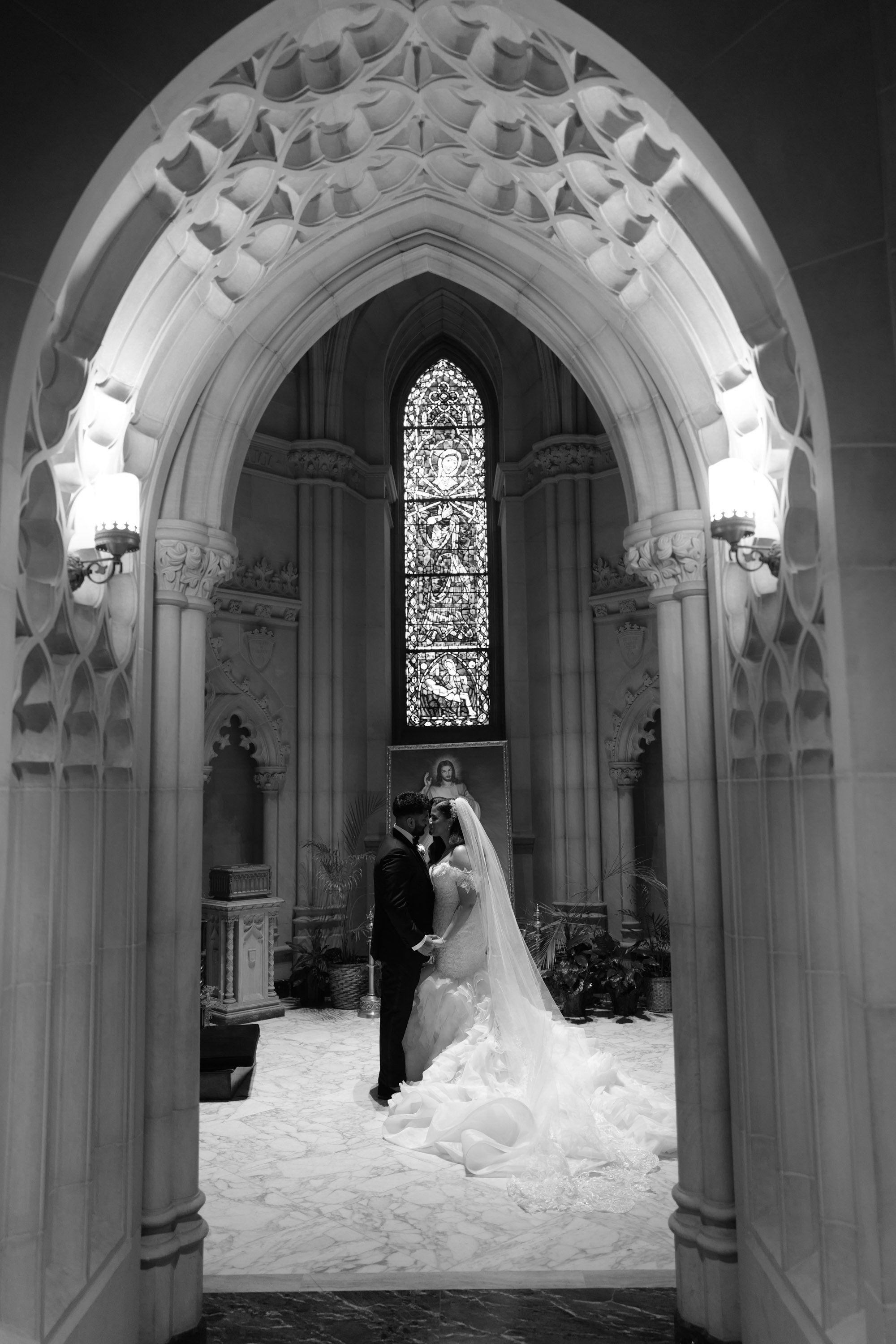 a bride and groom standing in the doorway of a church