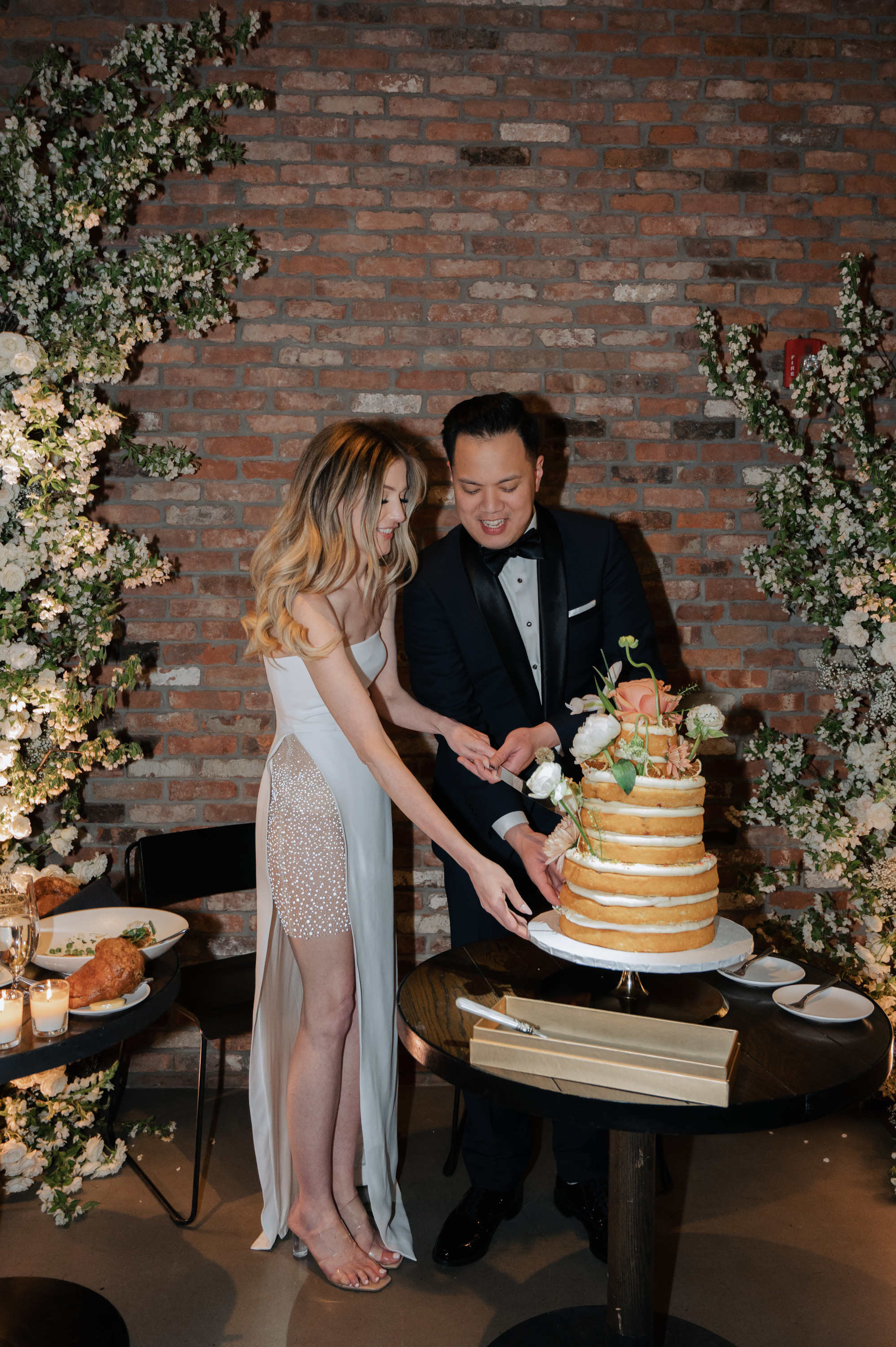 a man and woman cutting a cake together