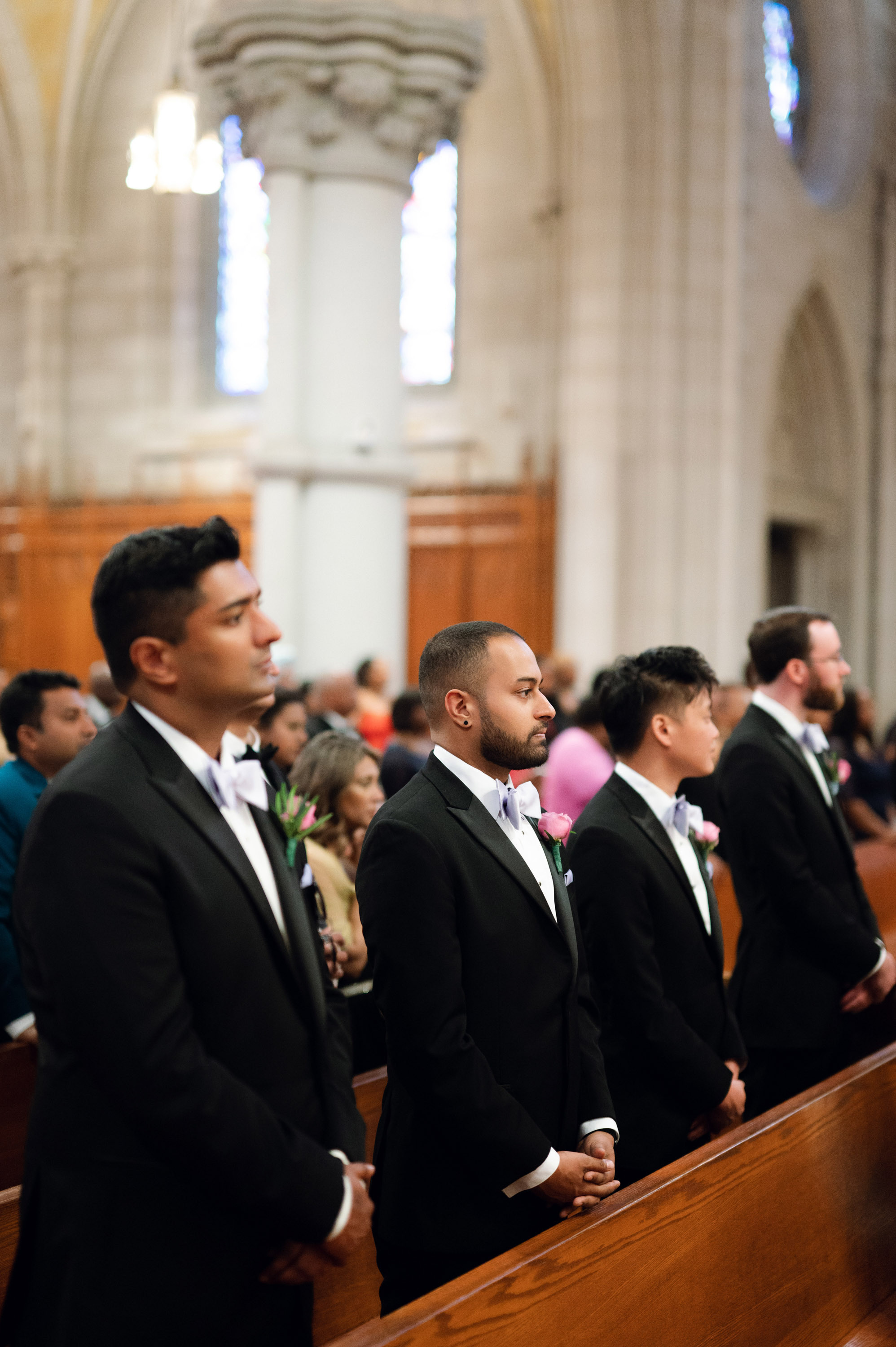 a group of men in suits and ties standing in a church