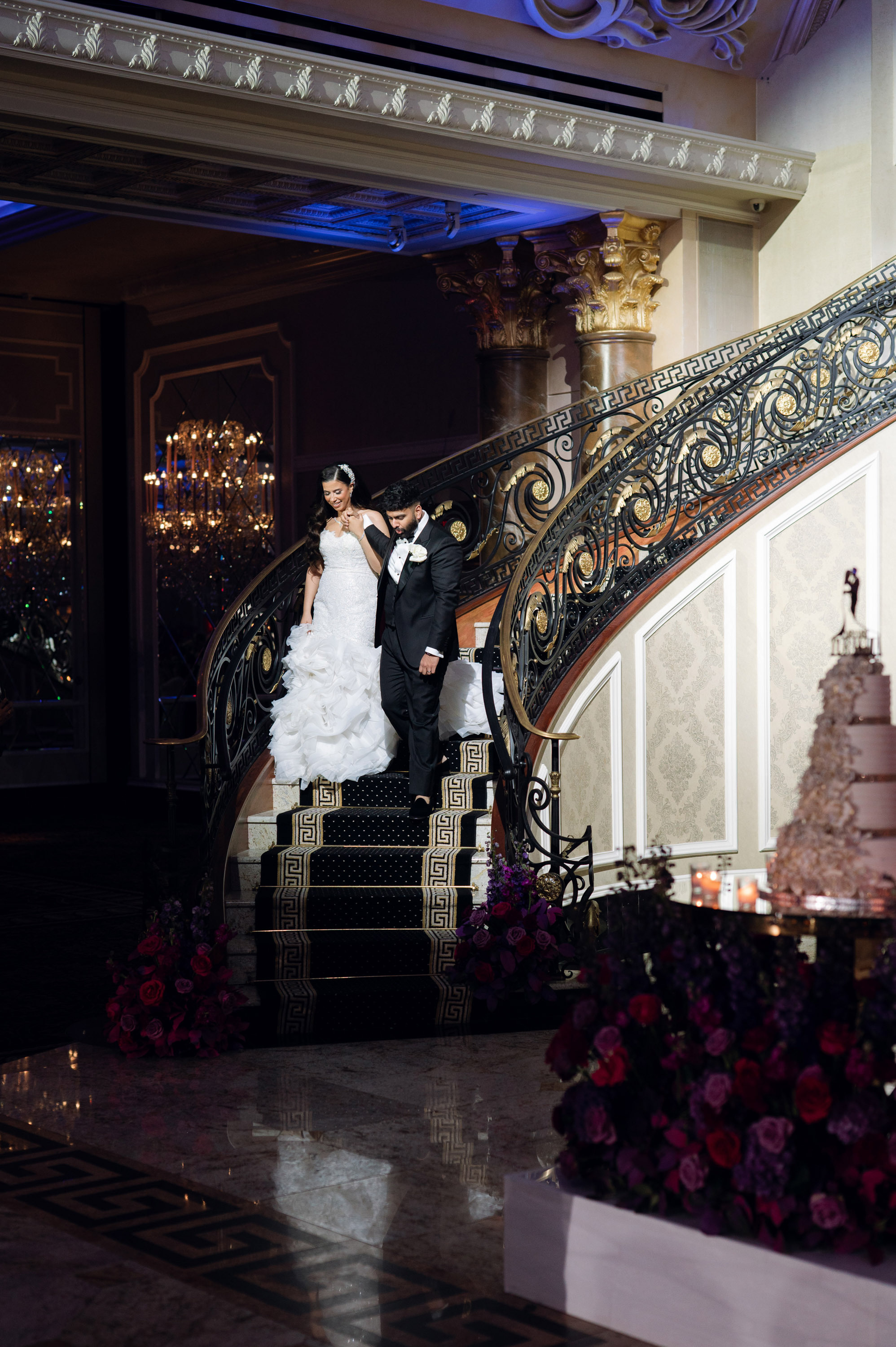 a bride and groom are posing on a staircase