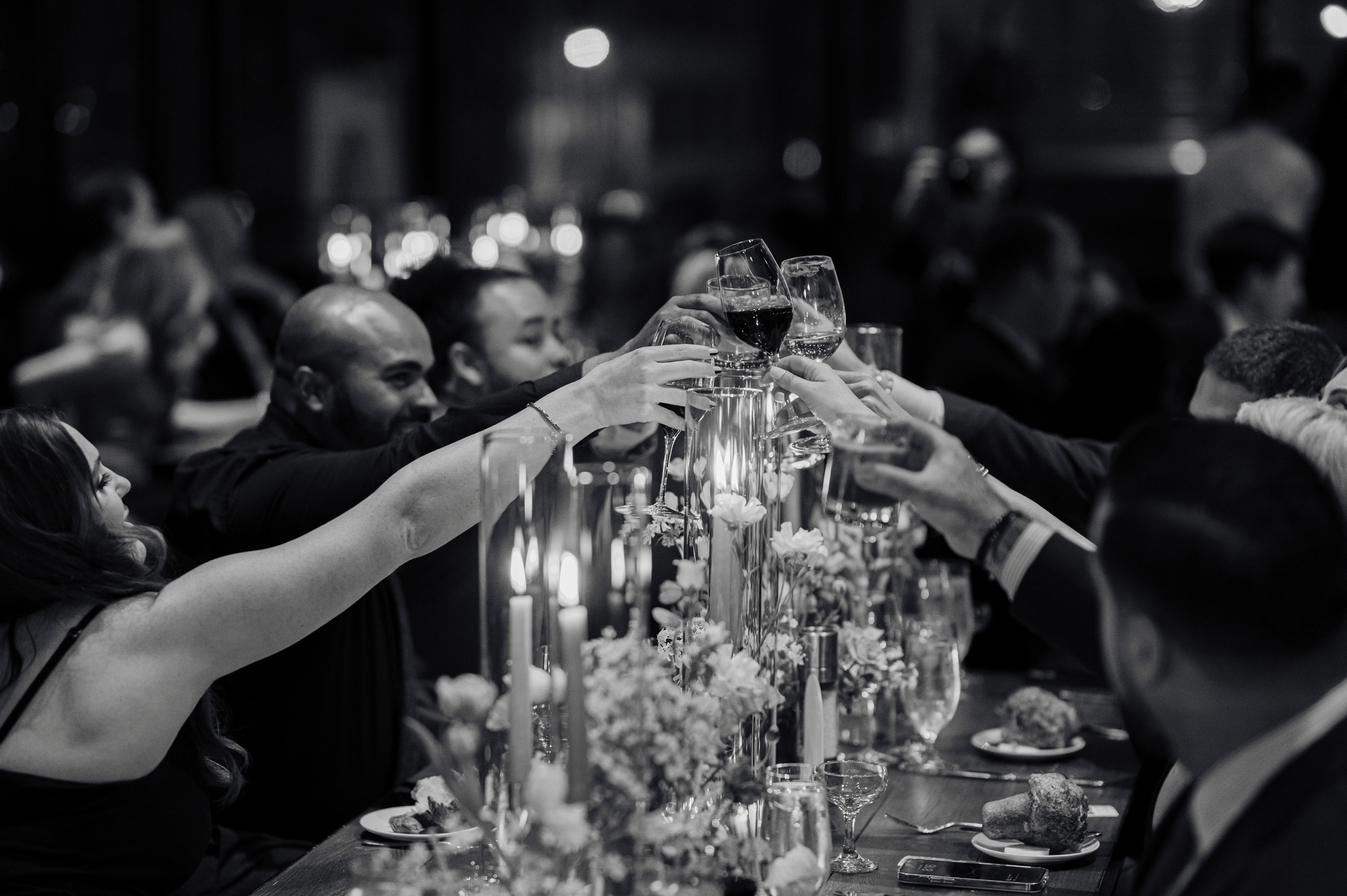 a group of people sitting at a table with wine glasses