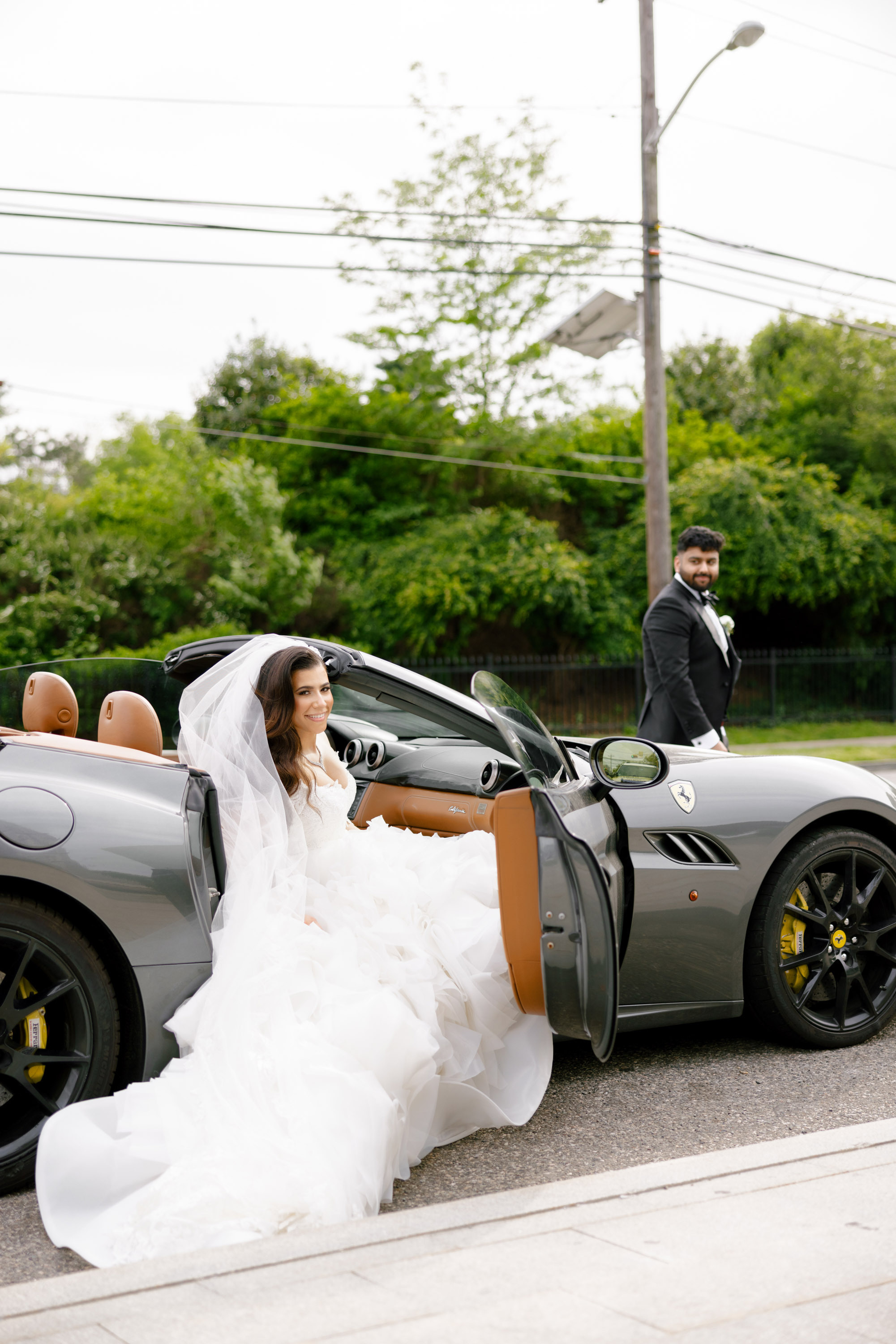 a bride and groom are sitting in a car
