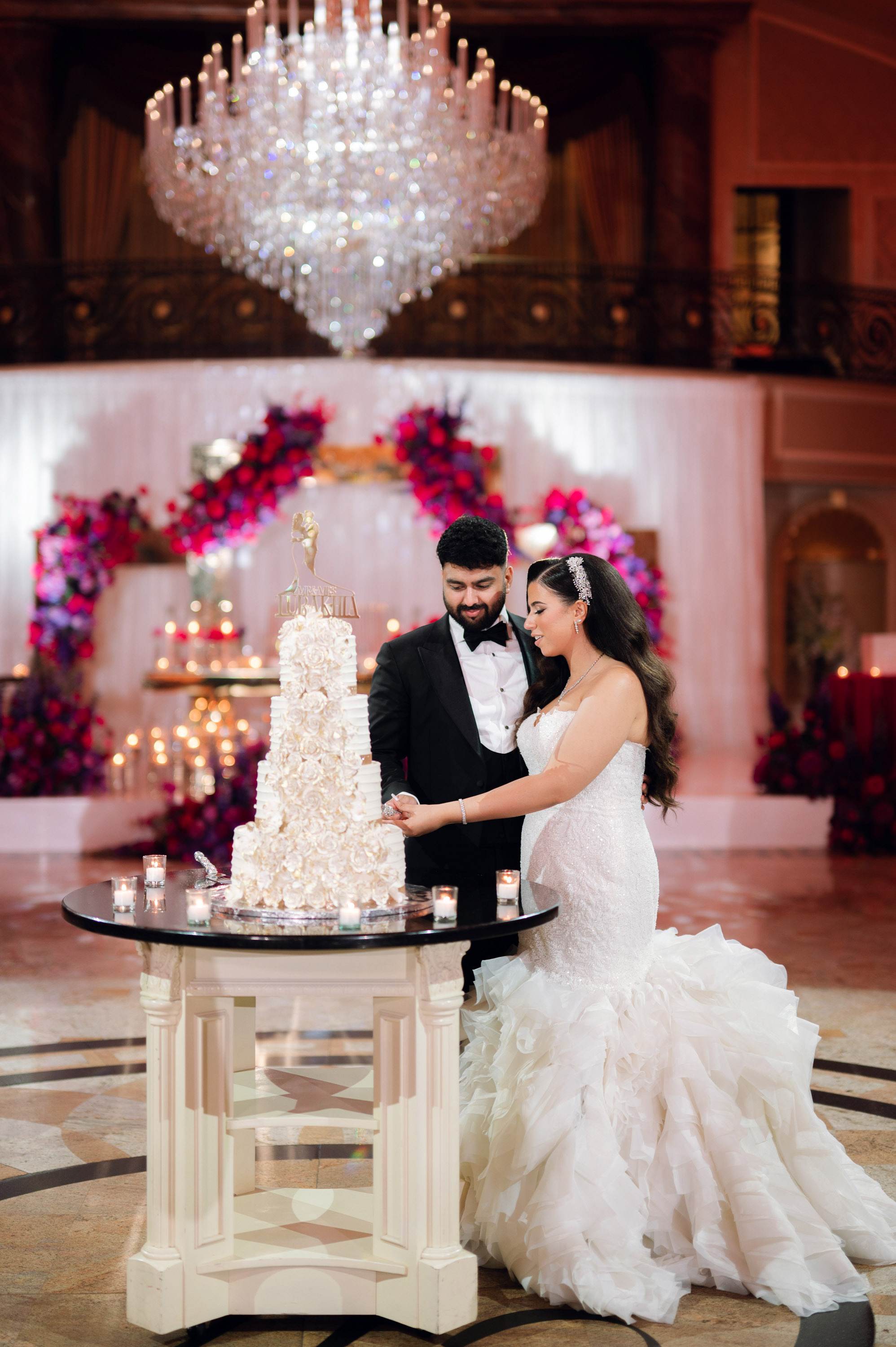 a bride and groom cutting a wedding cake