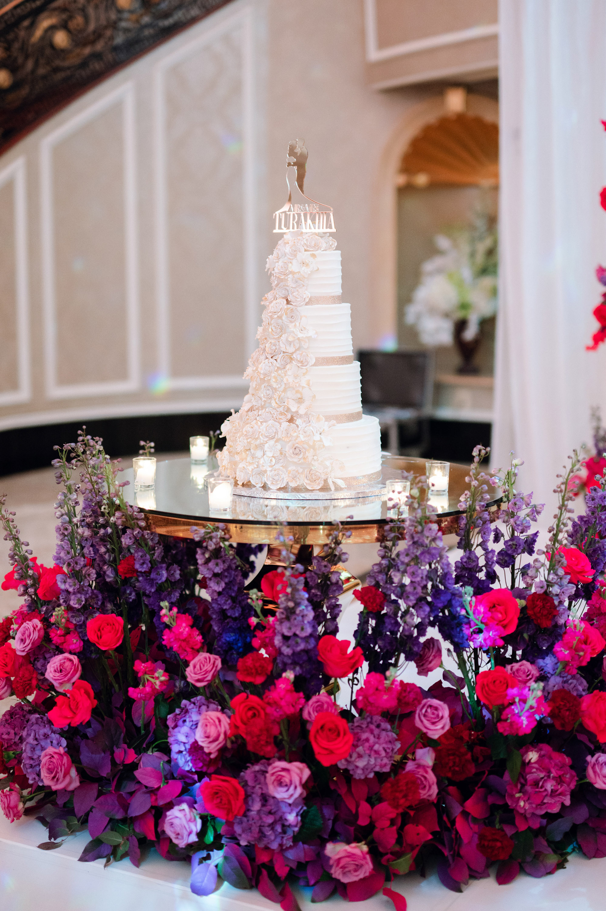 a wedding cake on a table with flowers