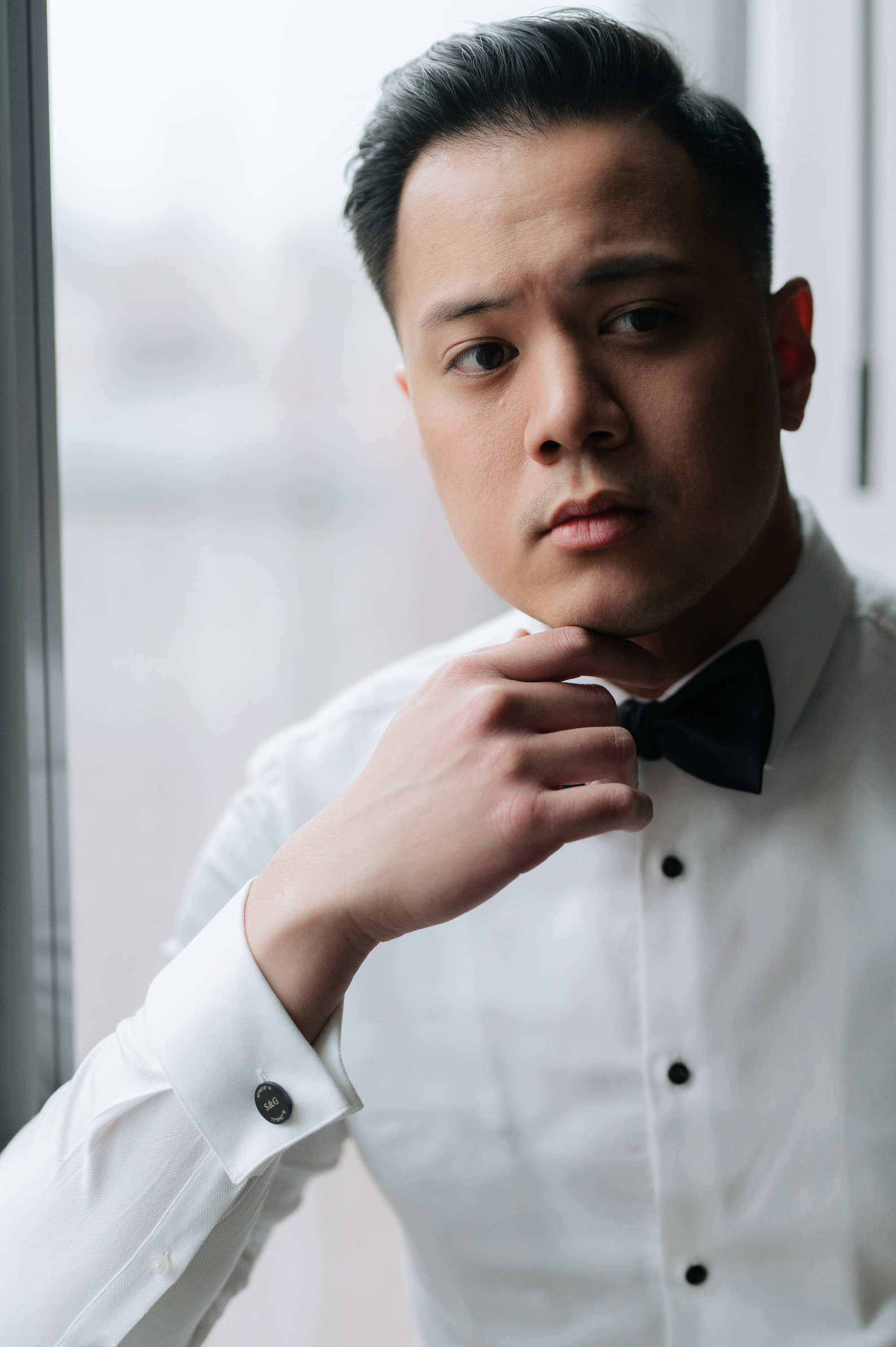 a man in a white shirt and bow tie