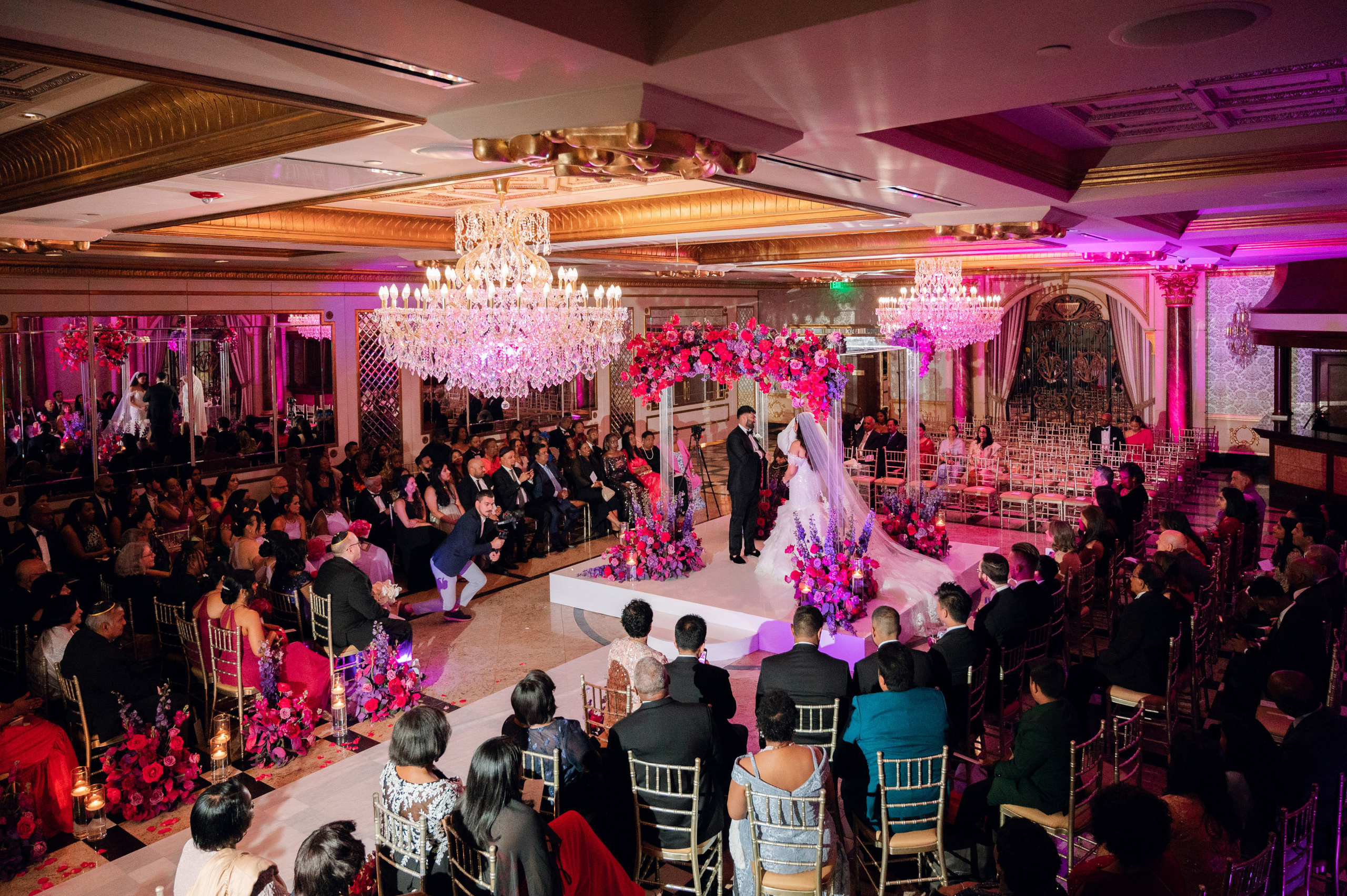 a wedding party with a couple and a couple on the dance floor