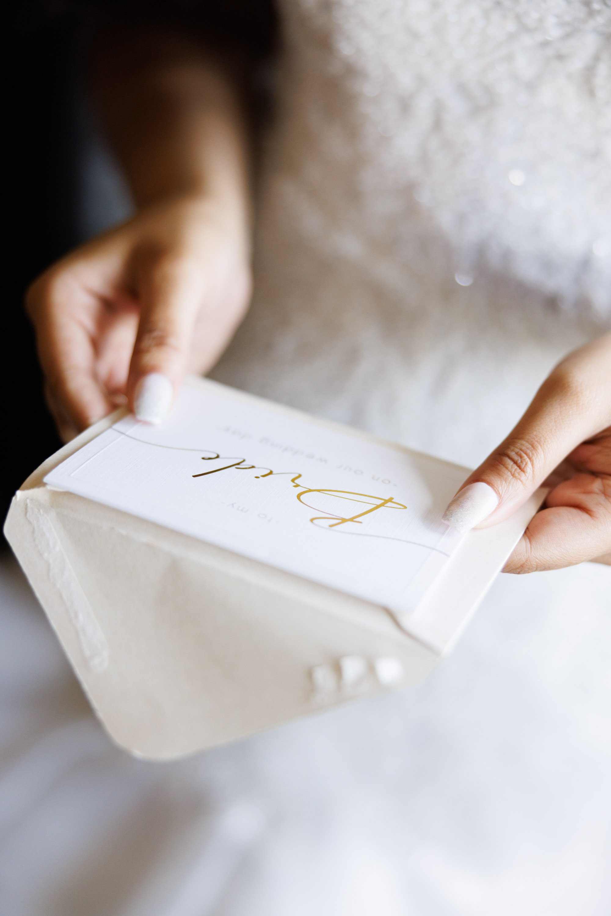 a person holding a box with a wedding card