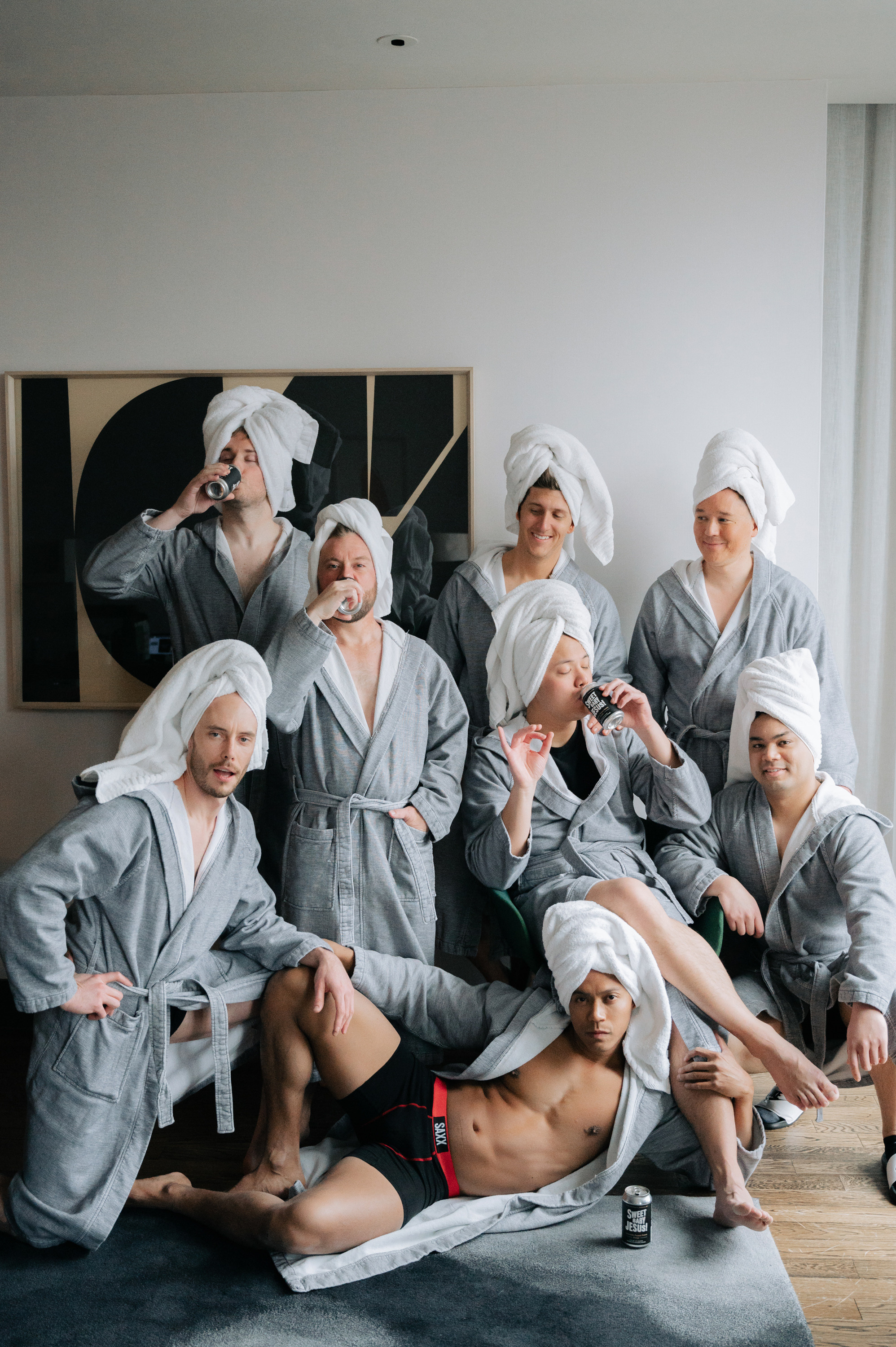 a group of people in robes sitting on a bed
