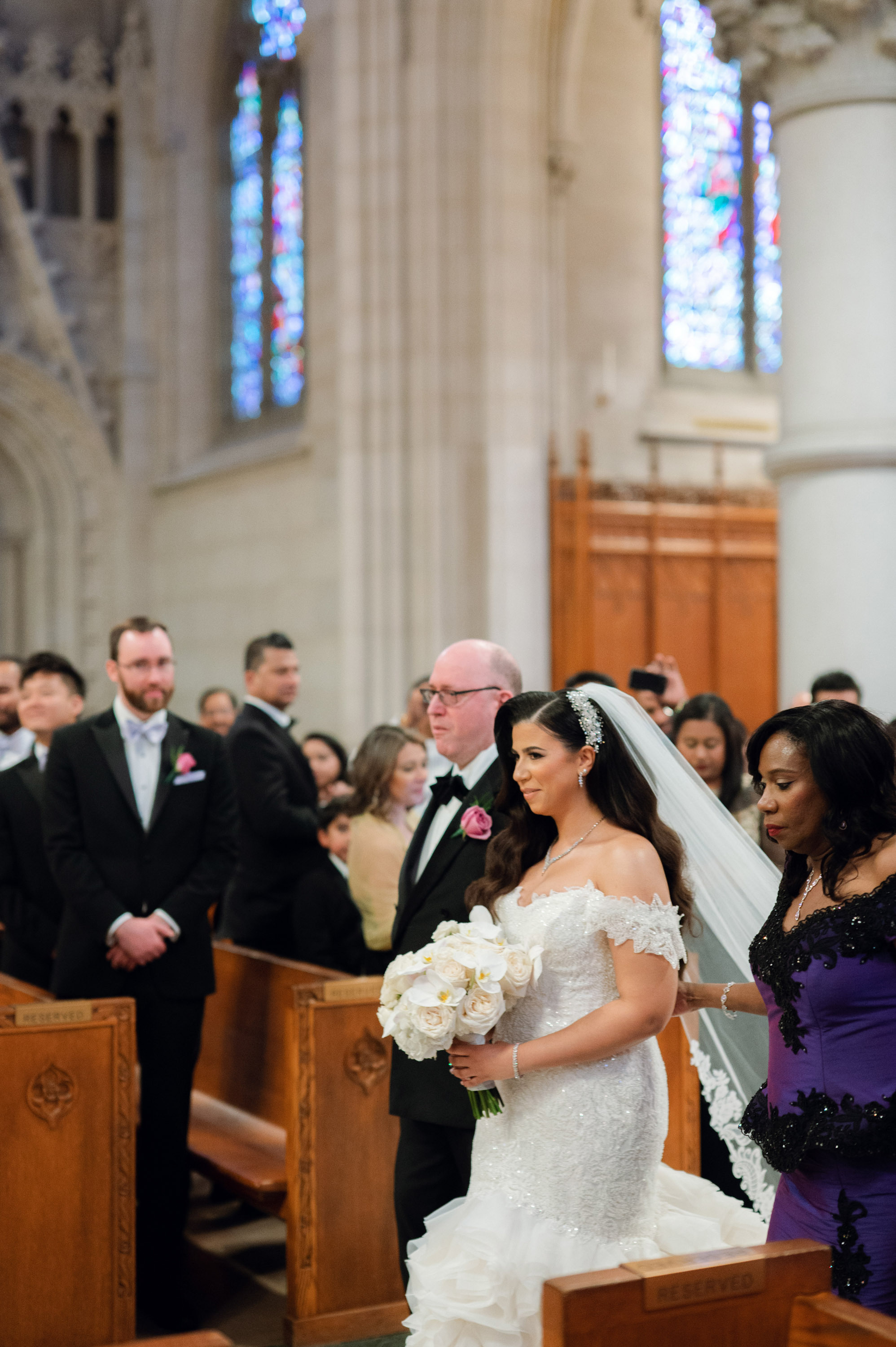 a bride walking down the aisle of a church