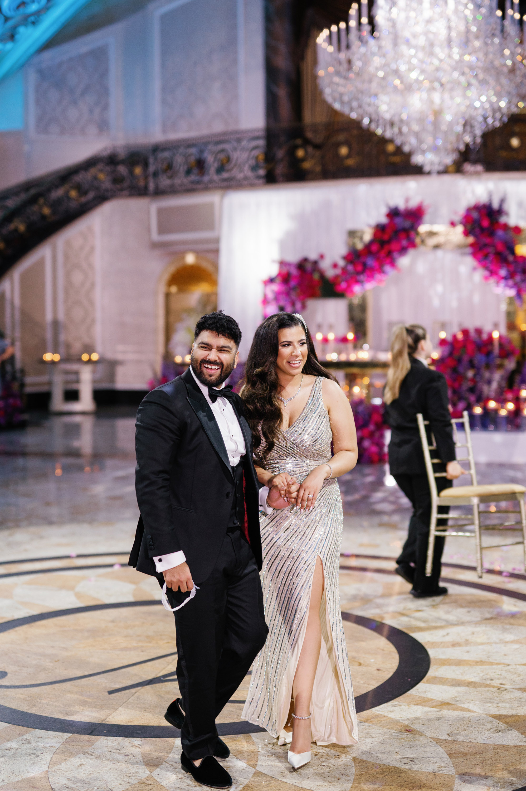 a couple posing for a photo in a ballroom