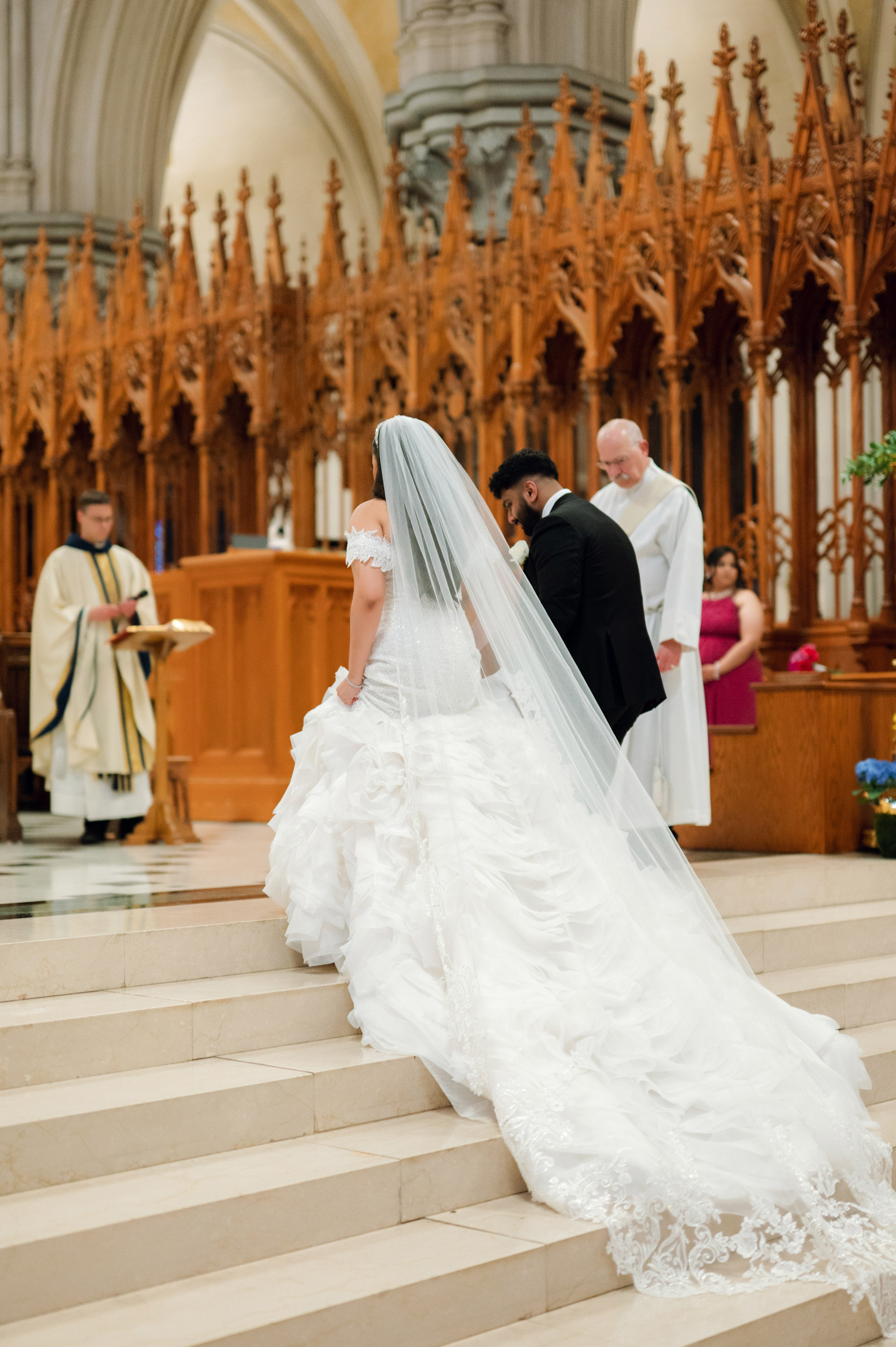 a bride and groom walking down the stairs