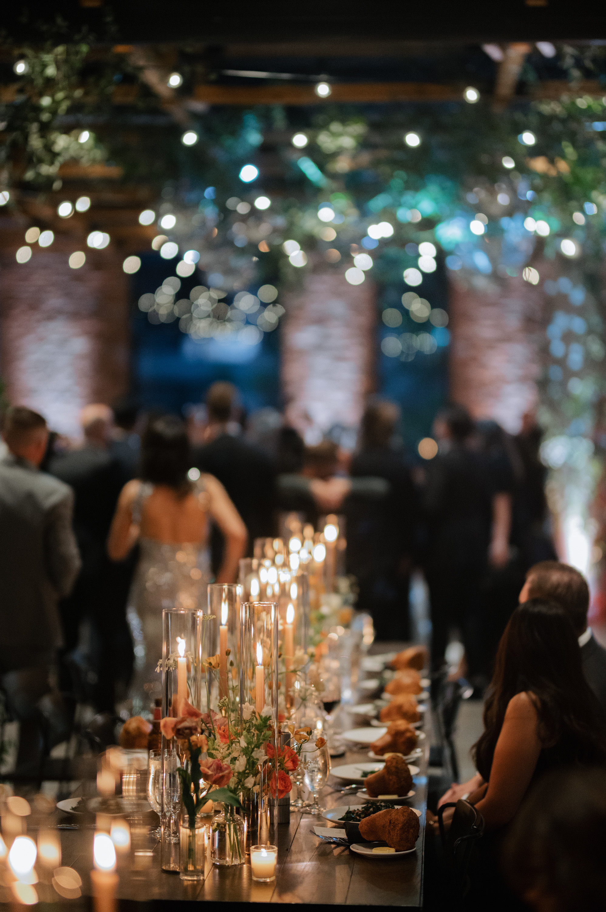a long table with candles and flowers on it