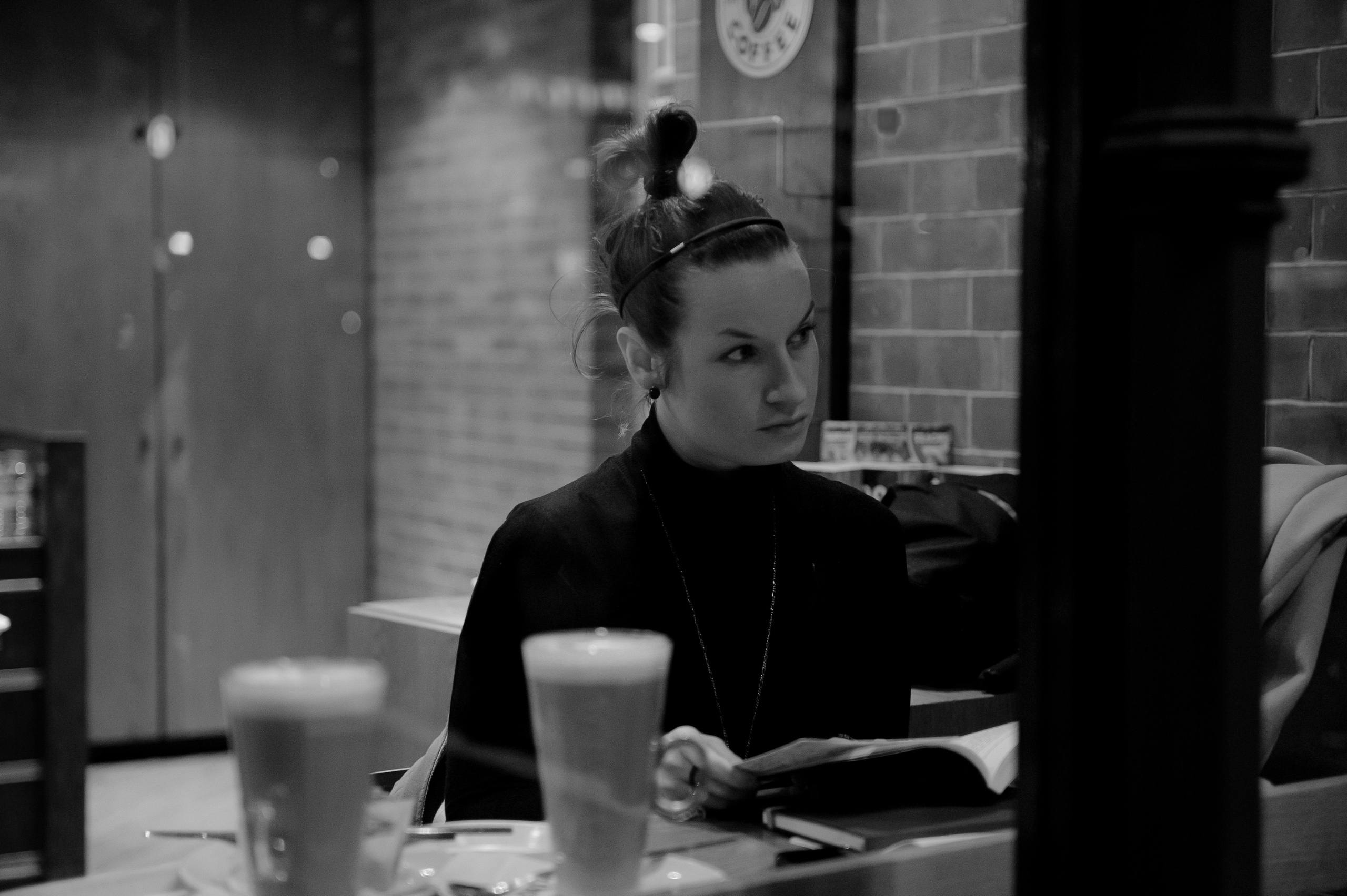 Woman reading a book at a café near King’s Cross, black and white portrait photography