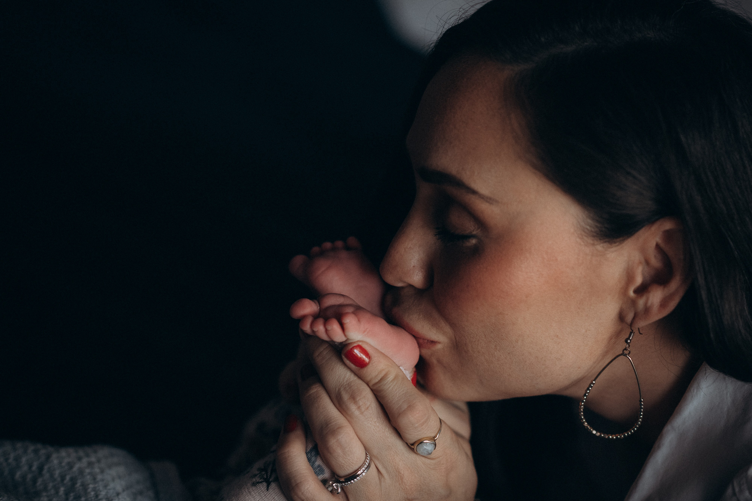 mum kissing baby feet 