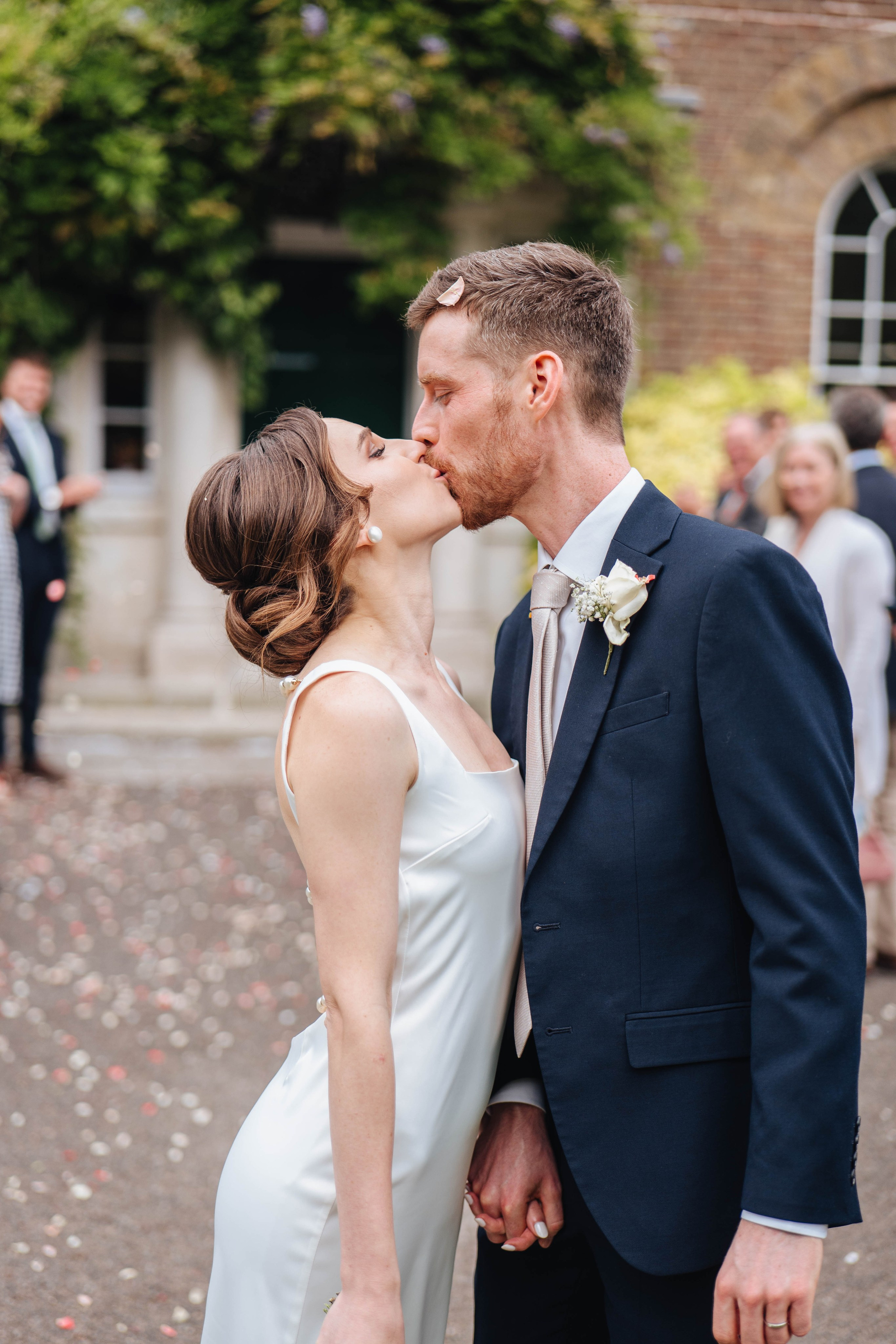 bride and groom kissing after confetti