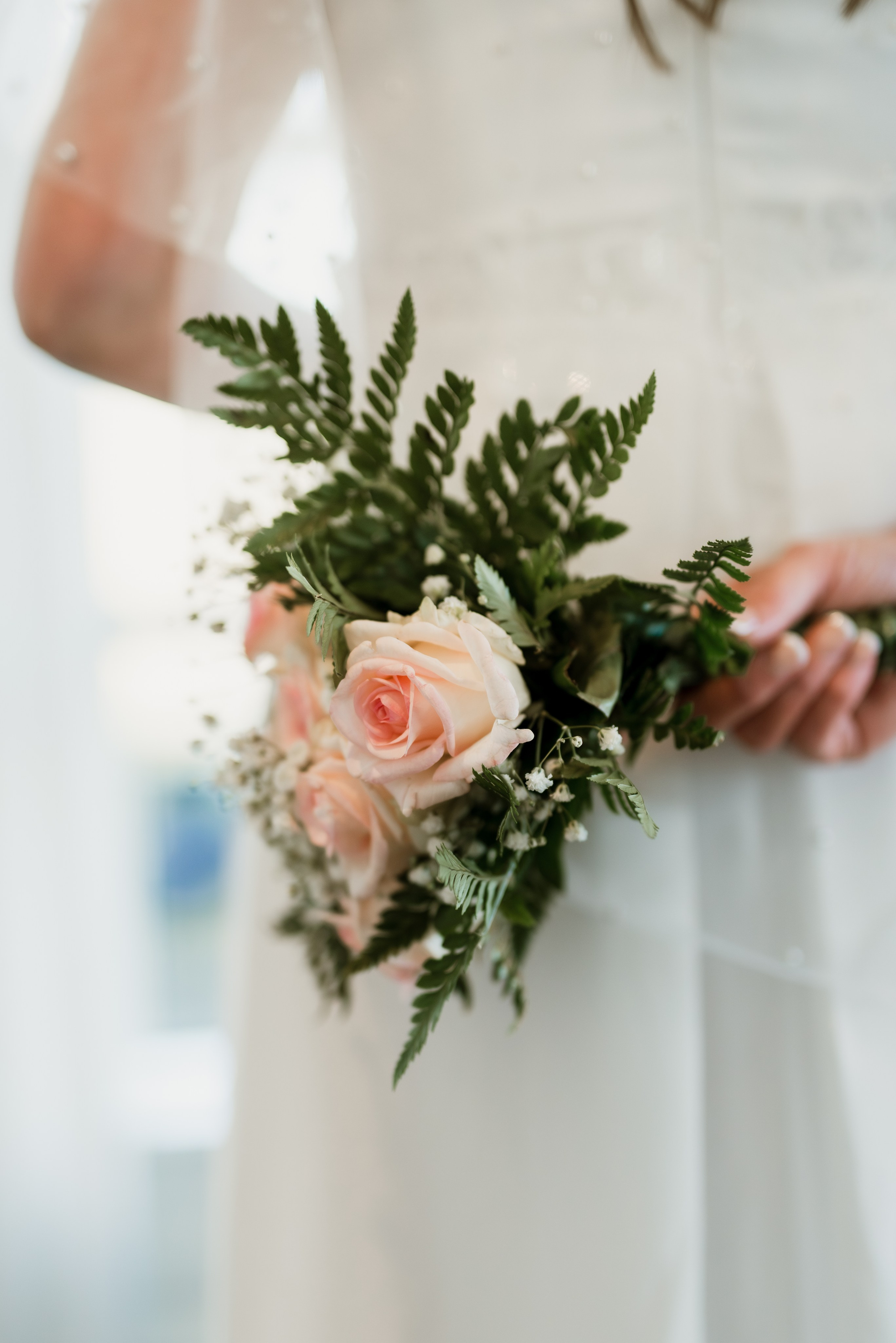 Bride in her wedding dress walking through the rustic halls of Hotel Búðir, the soft lighting creating a dreamy atmosphere.