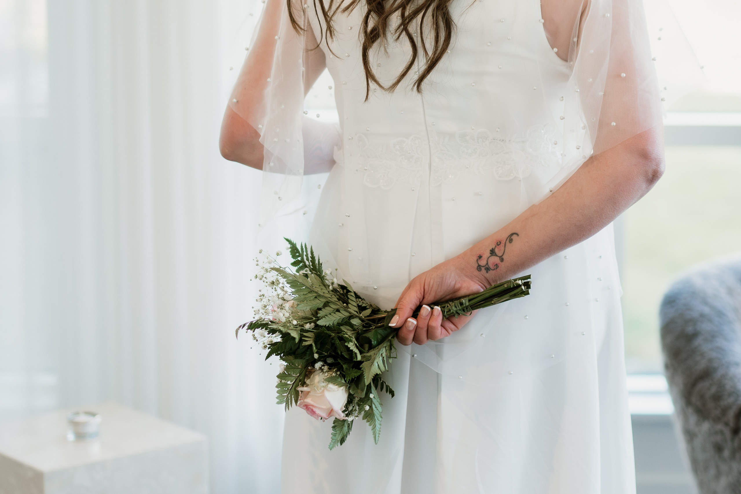 Bride in her wedding dress walking through the rustic halls of Hotel Búðir, the soft lighting creating a dreamy atmosphere.