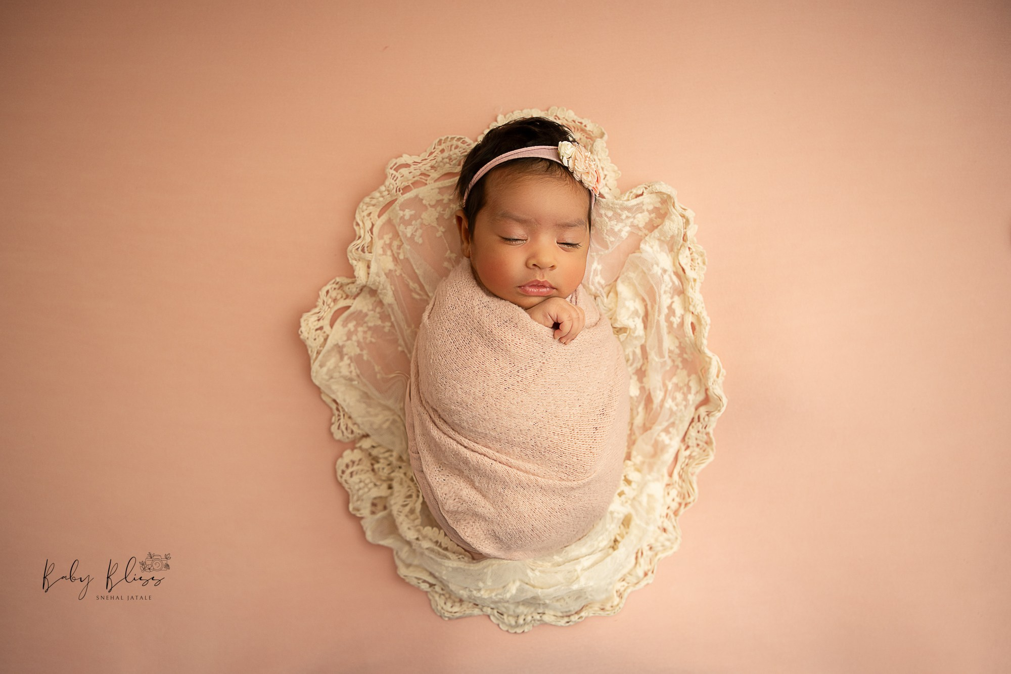 soft pastel pink newborn baby sleeping peacefully.