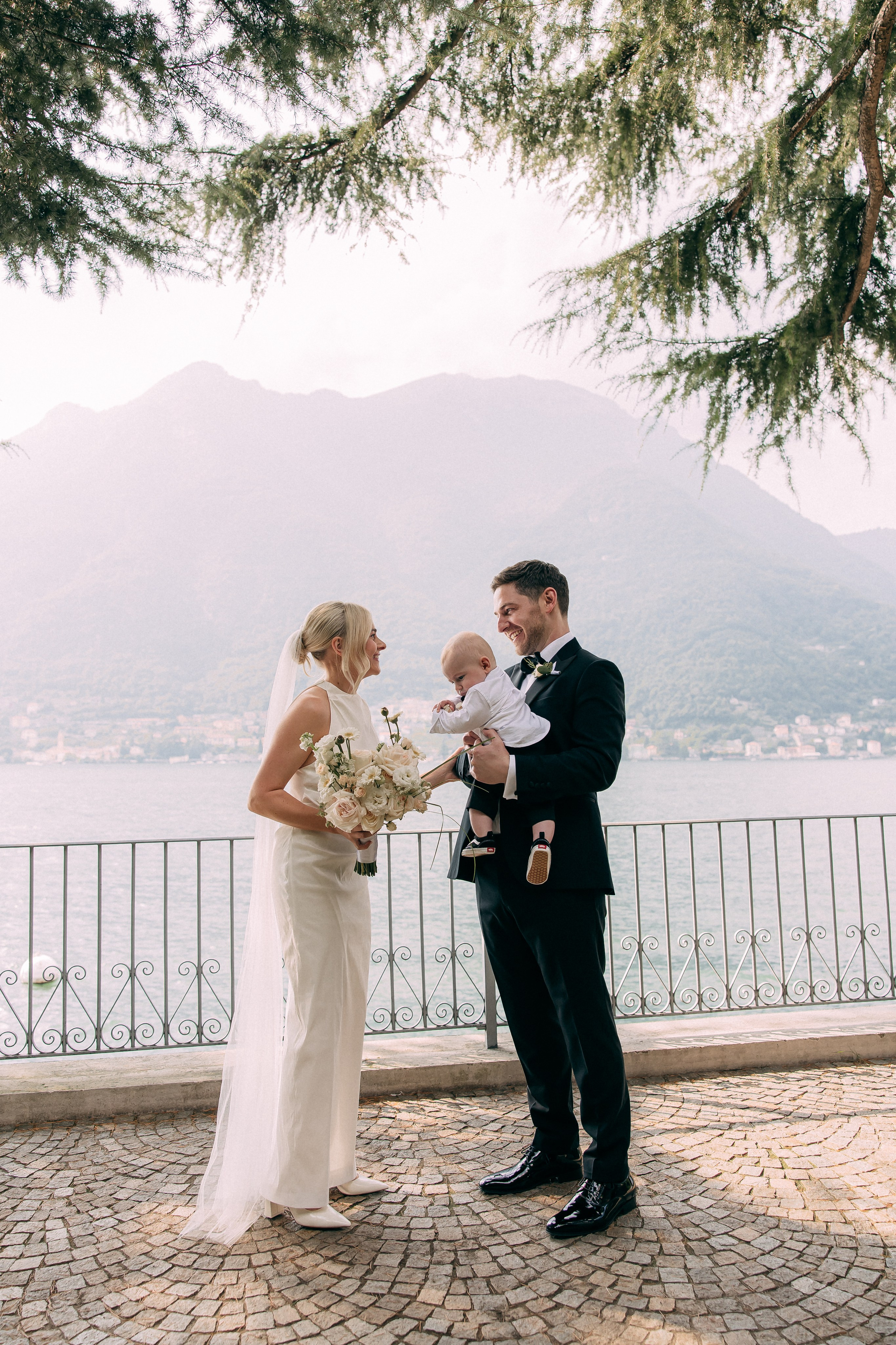 Bride and groom sharing a tender moment overlooking Lake Como at Villa Lario, Italy