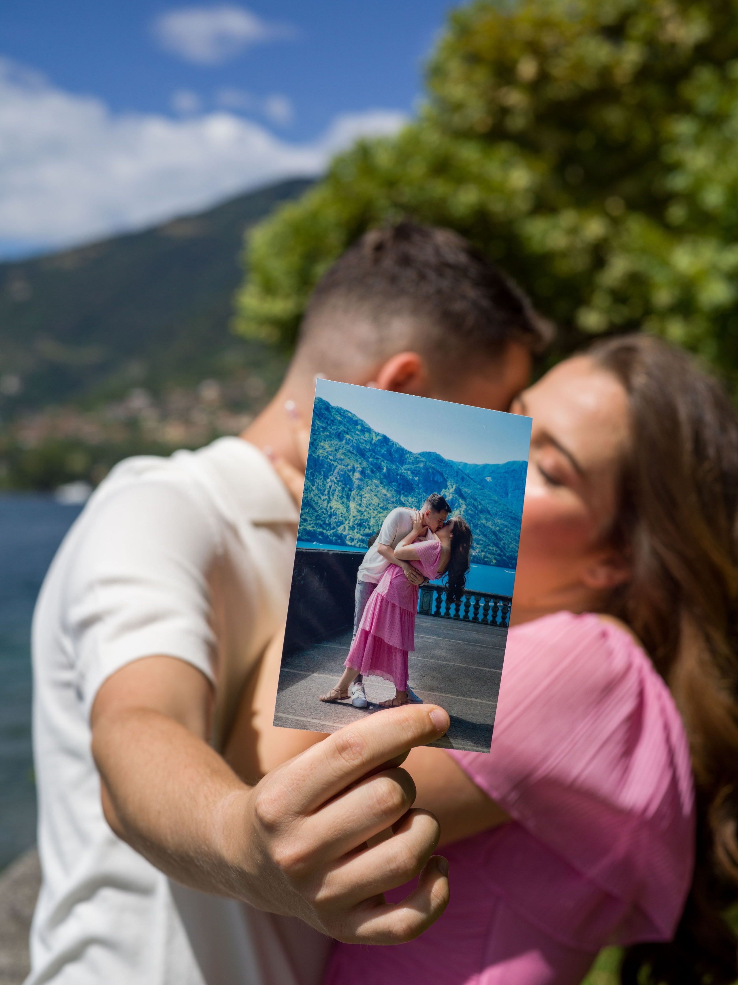 Proposal, Parco Civico Teresio Olivelli, Tremezzo, Lake Como – couple kissing behind an instant printed photo
