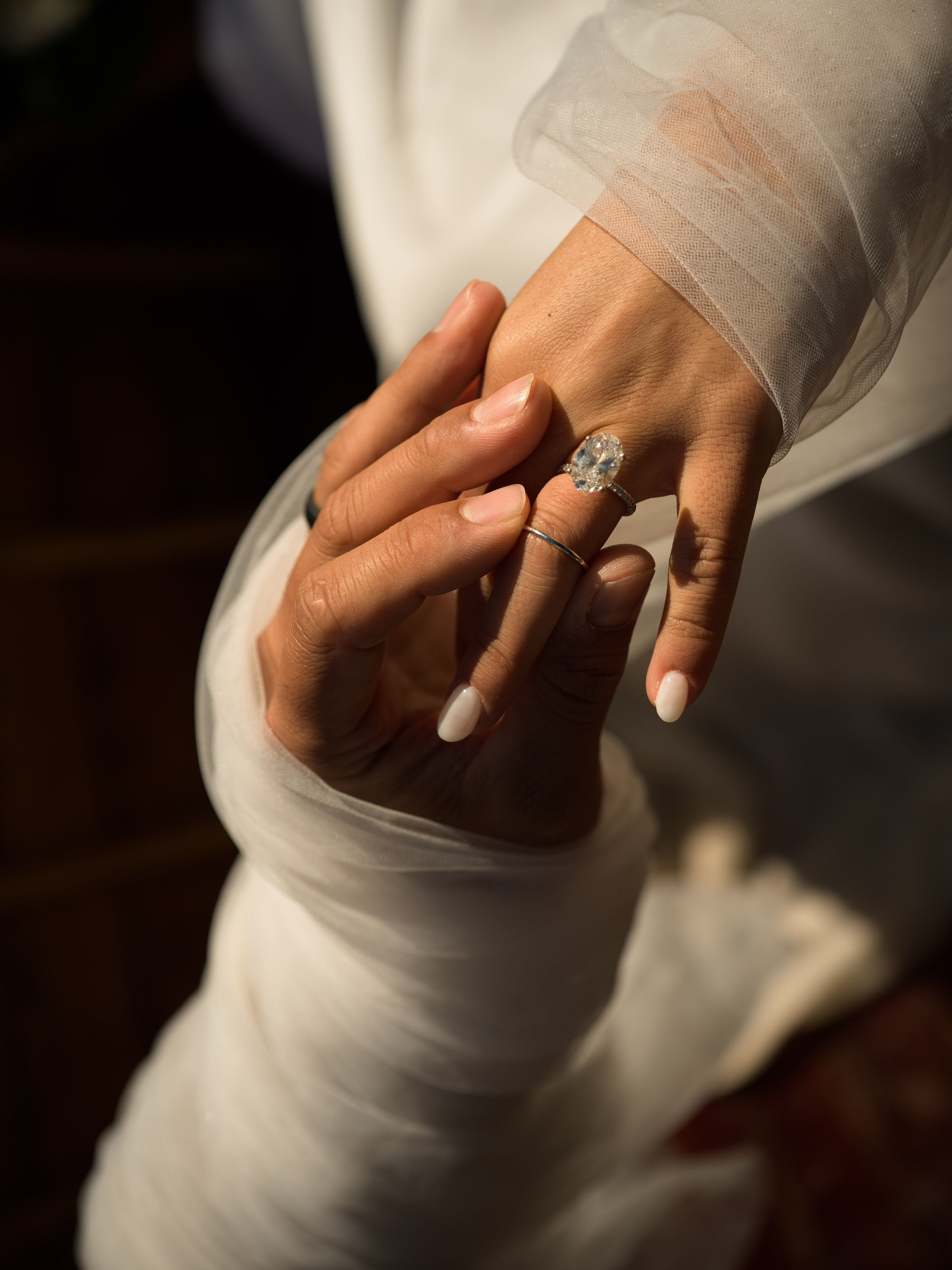 Lake Braies elopement ring exchange at sunrise, intimate couple moment on the shore of Lago di Braies in the Dolomites, Italy