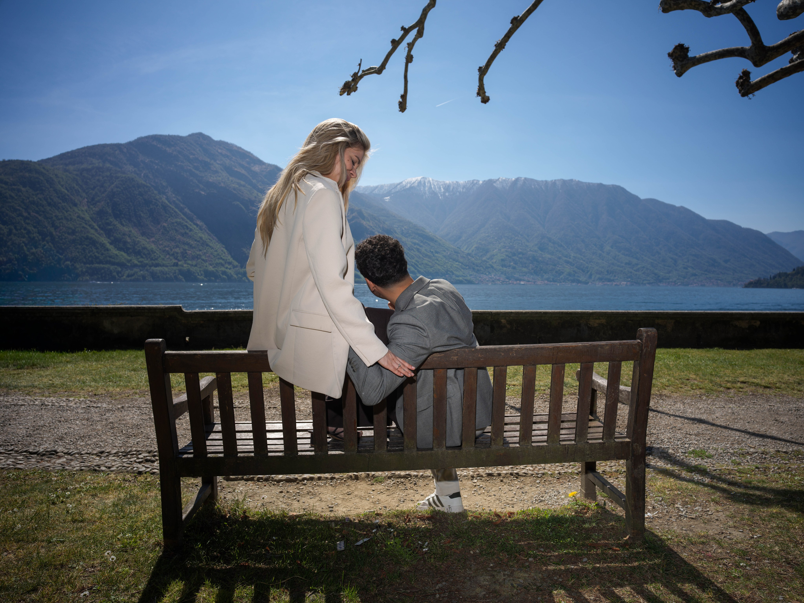 Proposal, Parco Civico Teresio Olivelli, Lake Como – couple sitting together on a bench, embracing after the proposal