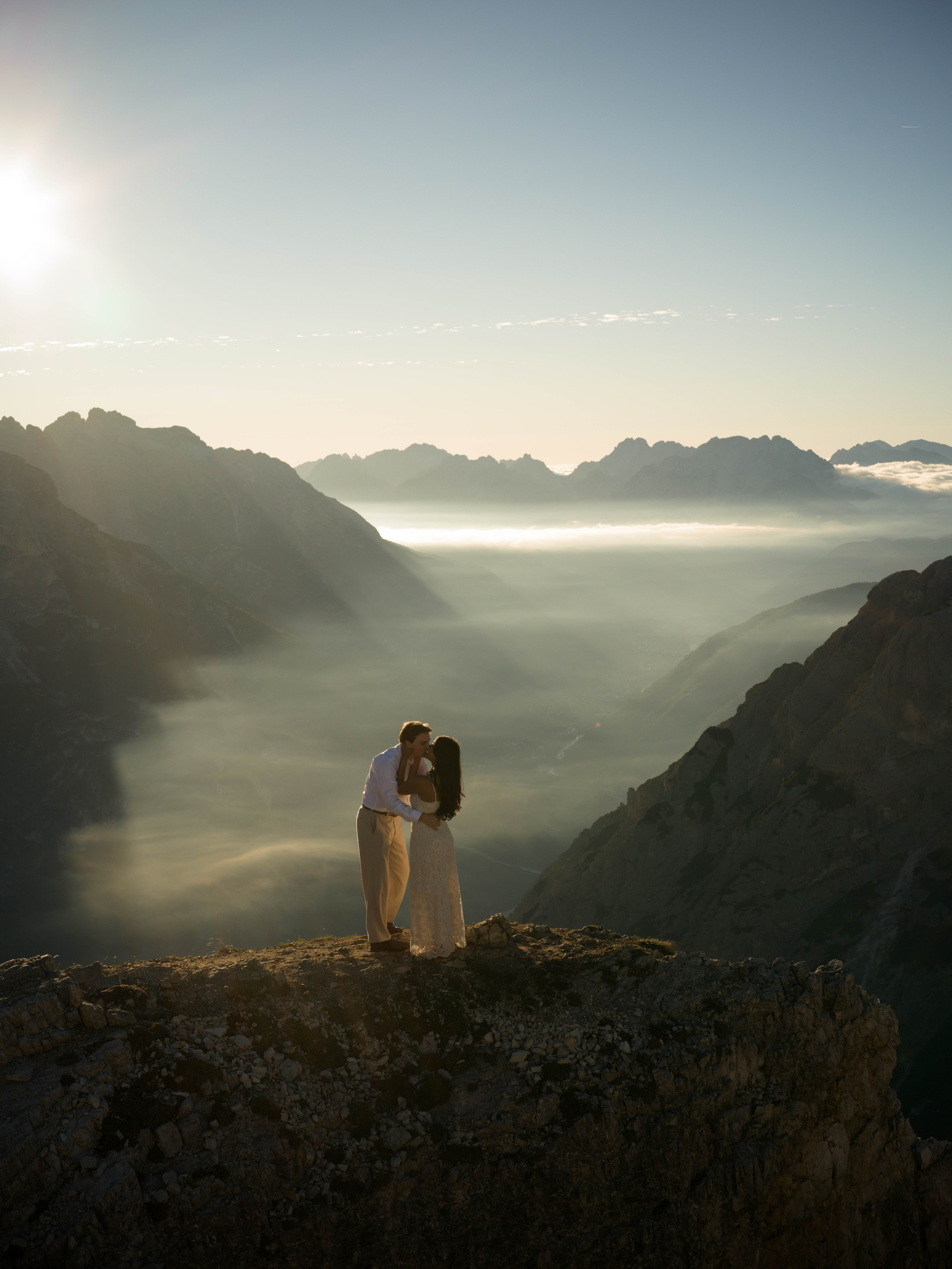 Sunrise proposal at Cadini di Misurina in the Dolomites, documenting a cinematic love story with Tre Cime di Lavaredo behind the couple.