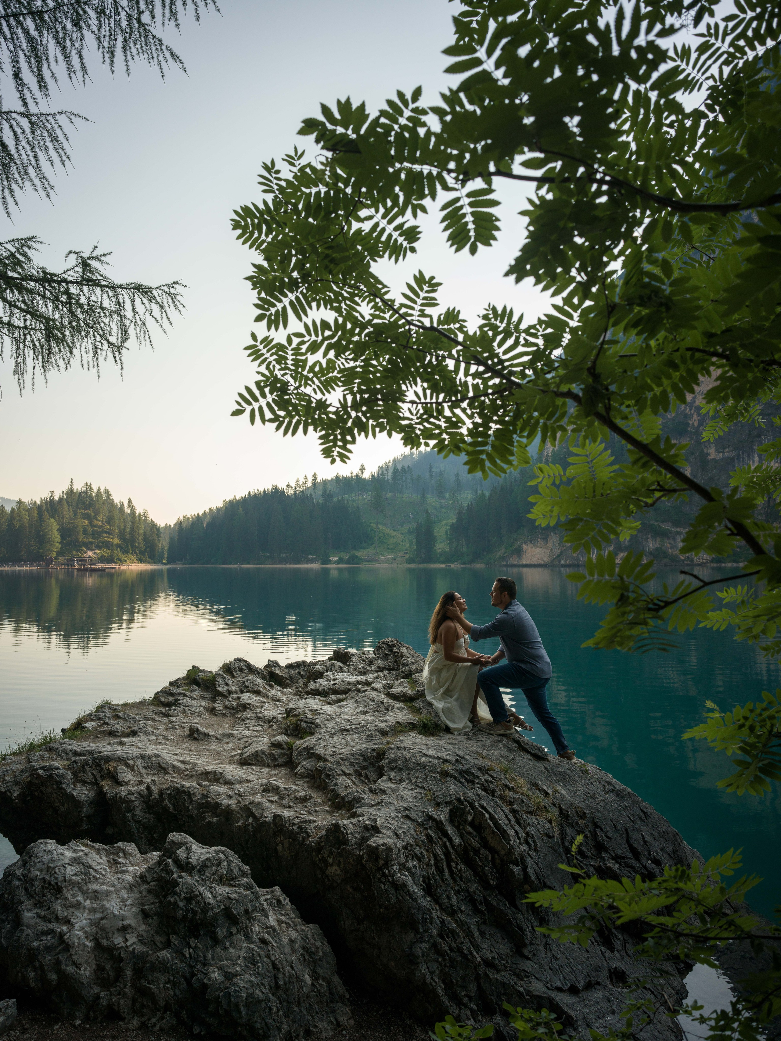 Cinematic couple photography at Lake Braies surrounded by the Dolomites