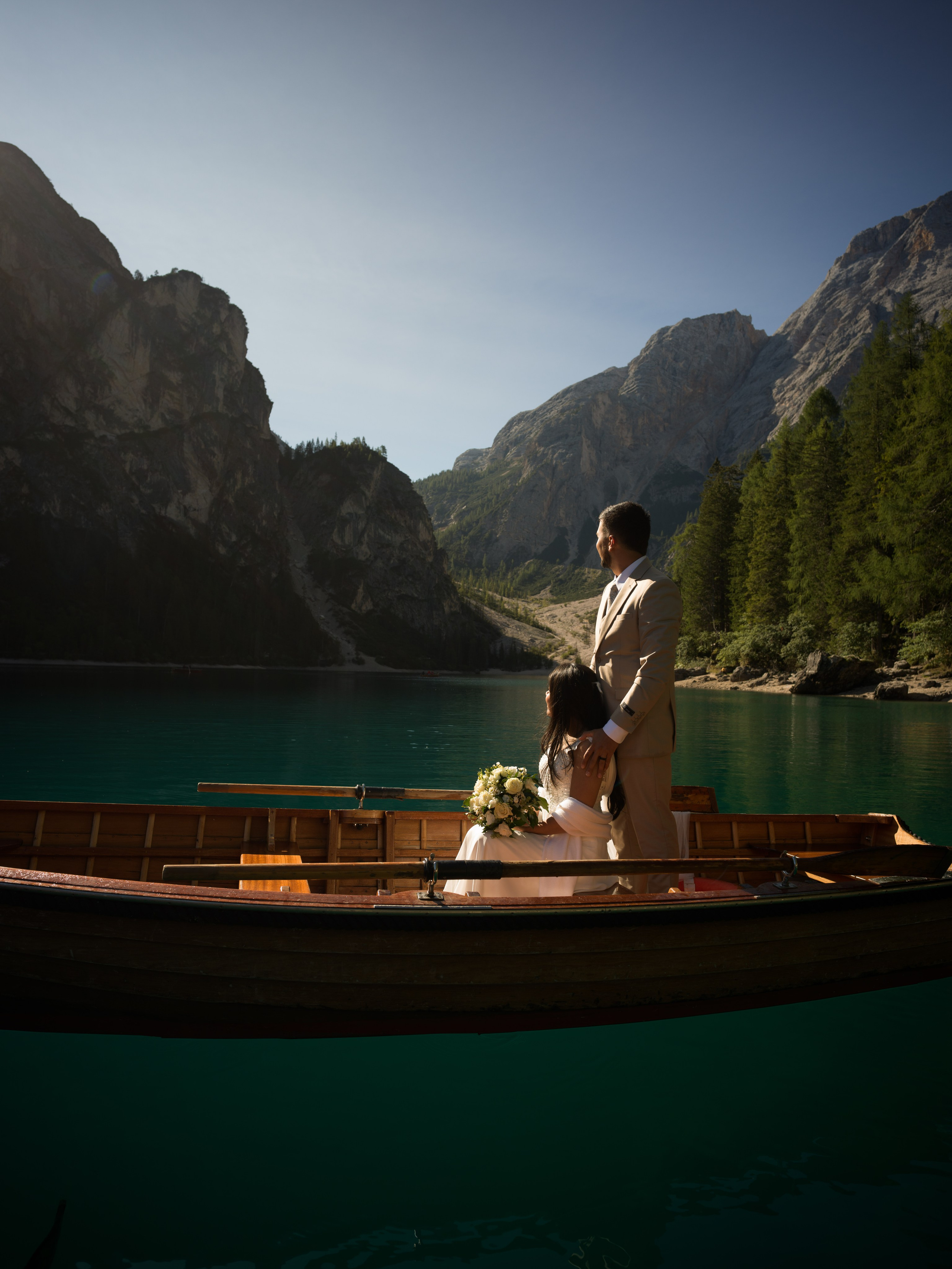 Cinematic Lake Braies elopement photography and video in the Dolomites with couple portraits on the lake and shoreline