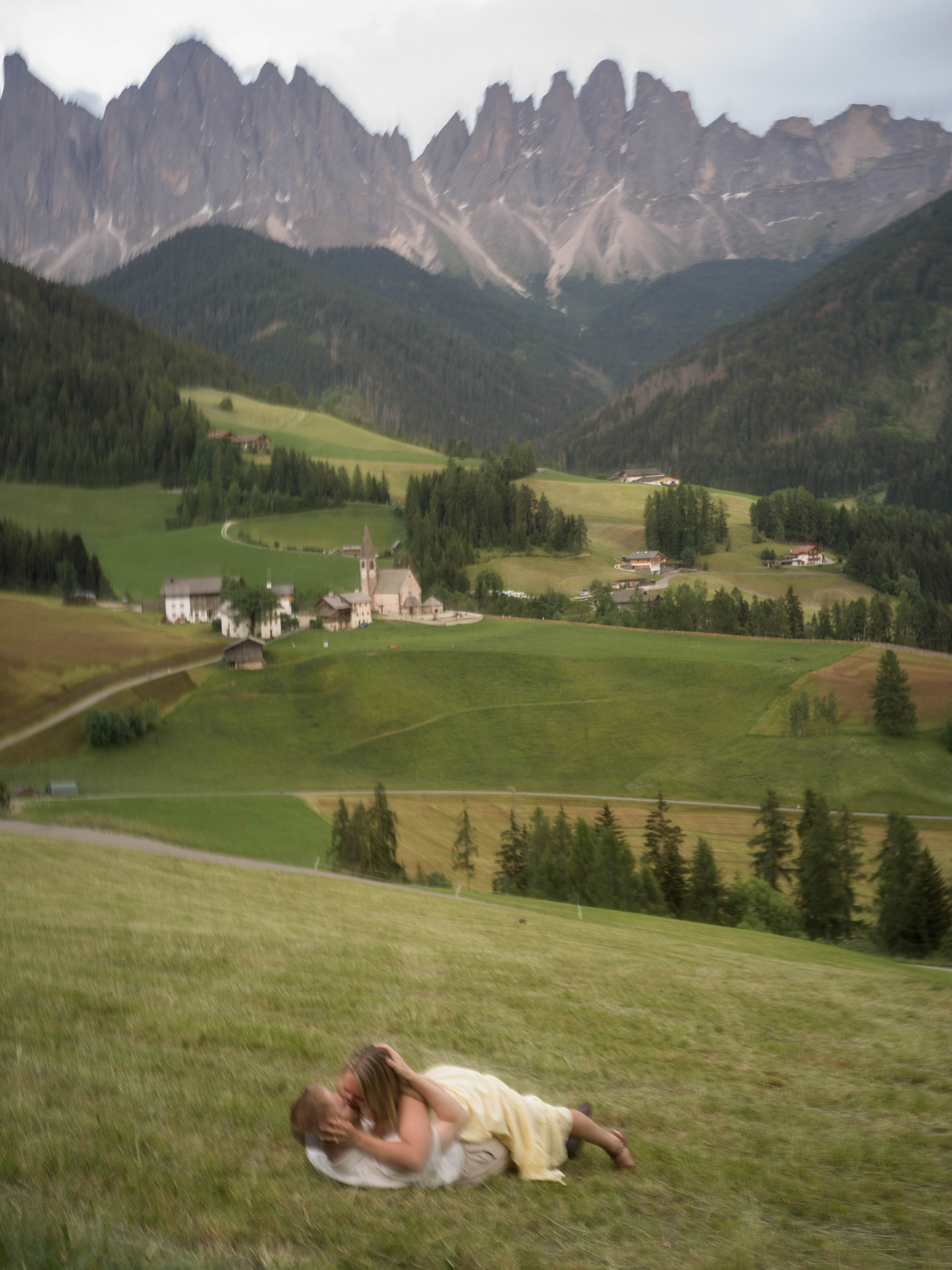 Couple during a surprise proposal with the Geisler peaks behind them in Santa Maddalena