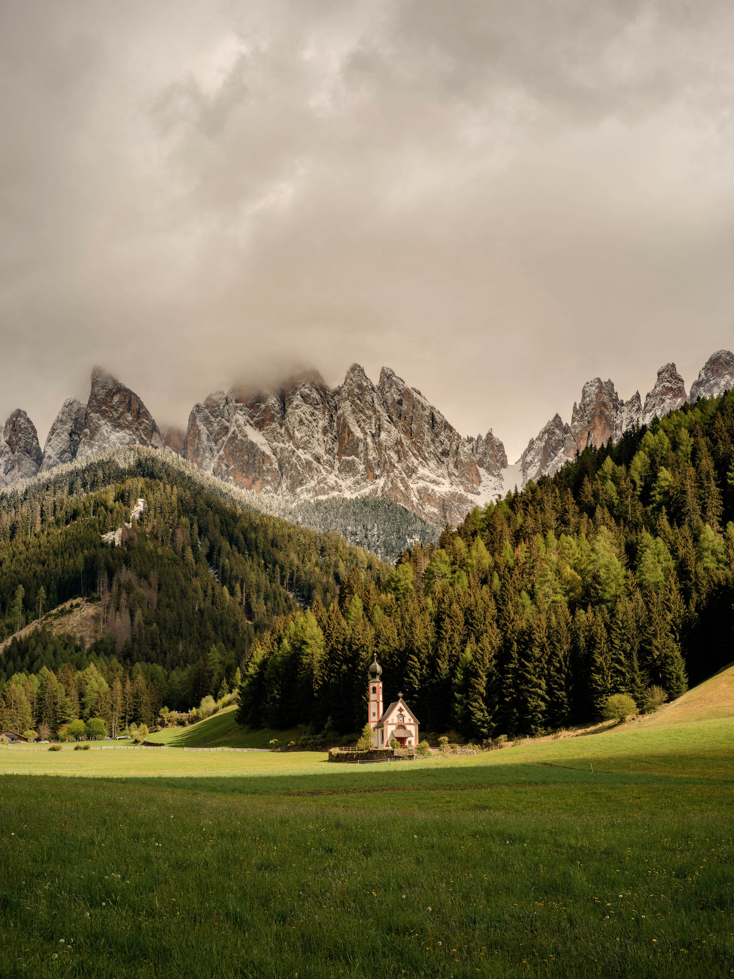 St. John’s Church (San Giovanni) in Val di Funes surrounded by the dramatic Dolomite peaks, Italy