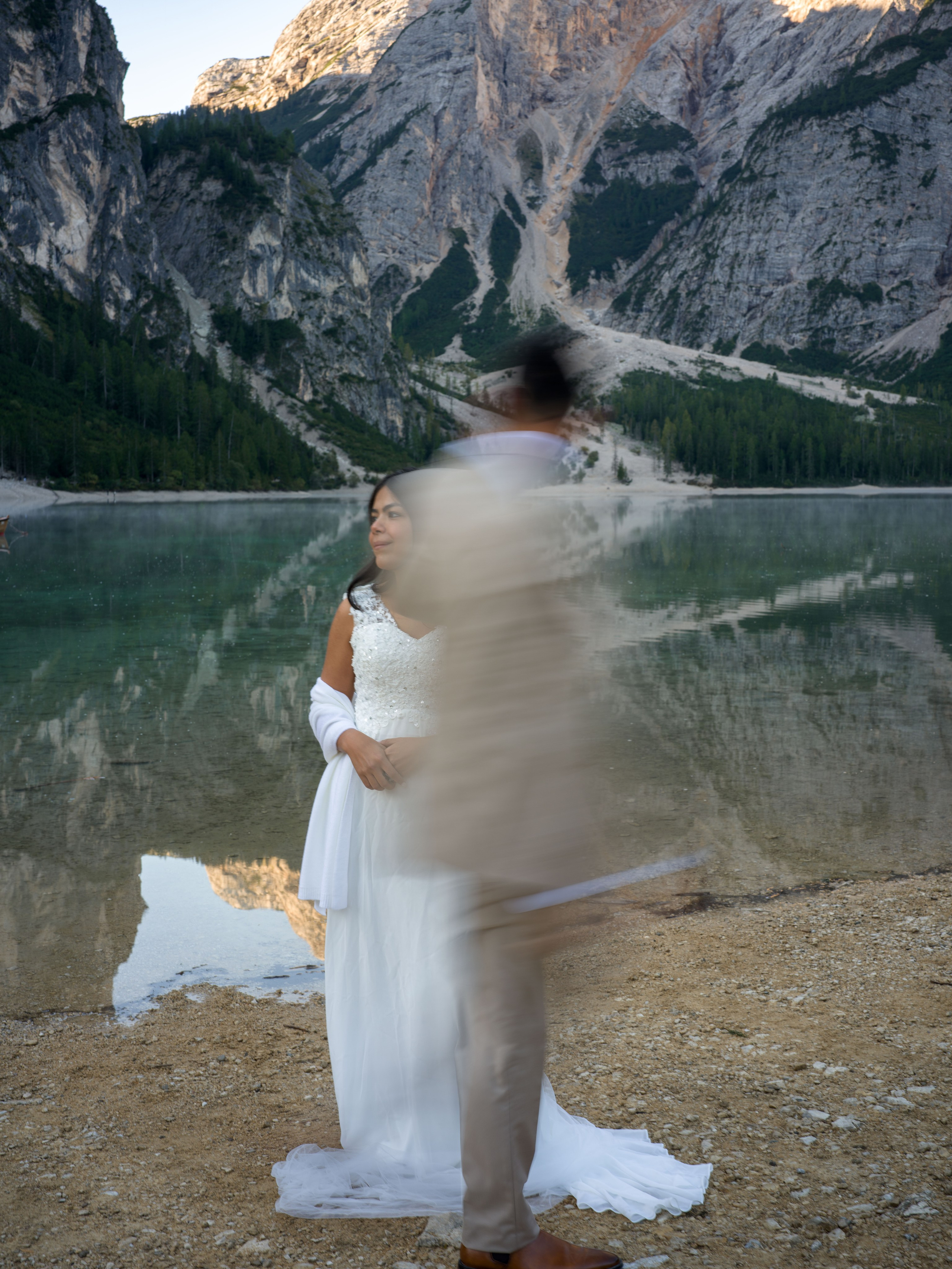 Dolomites elopement at Lake Braies with romantic couple photography and cinematic video on a traditional wooden boat