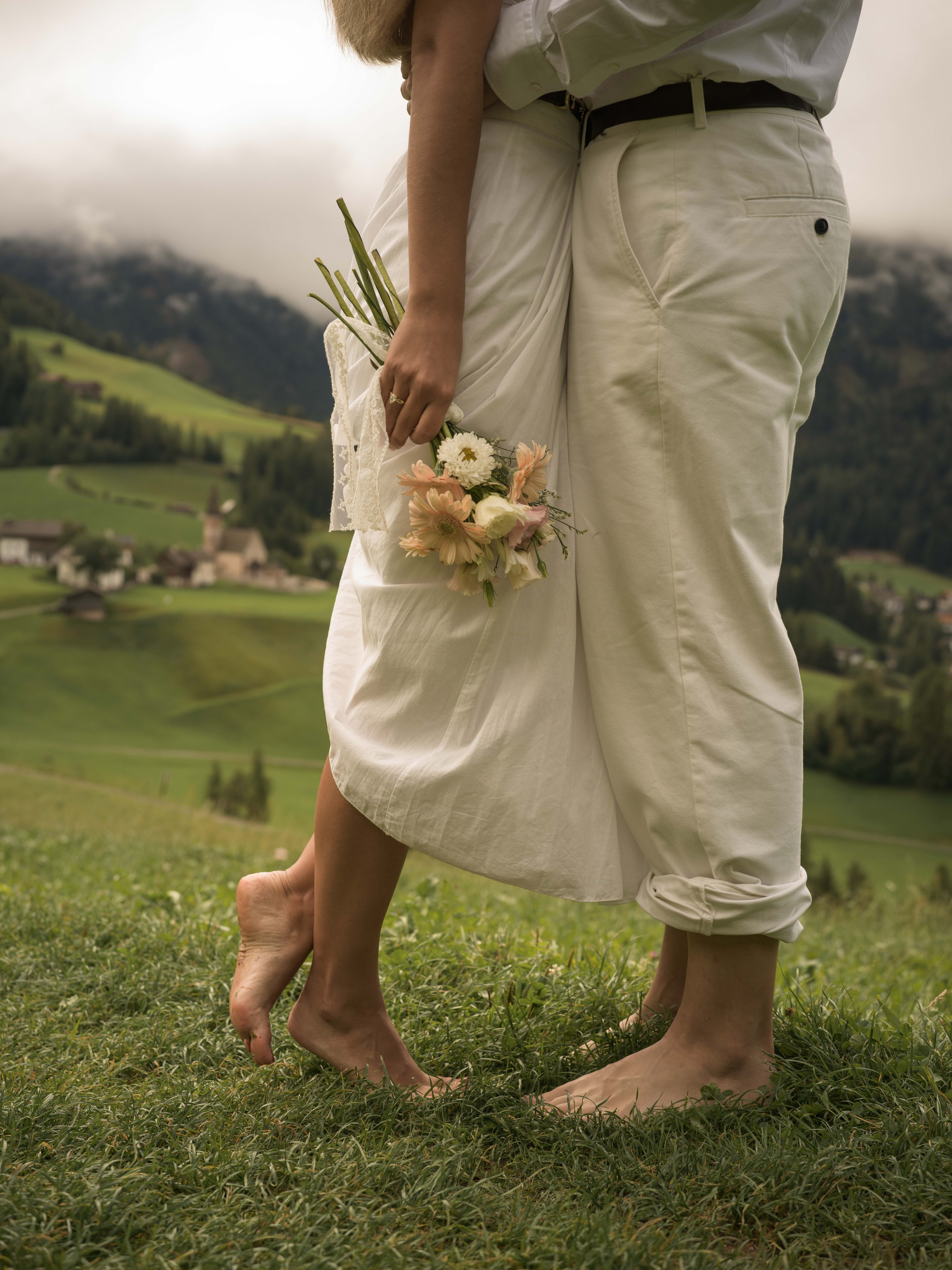 Santa Maddalena surprise proposal photography in Val di Funes, Dolomites, Italy, captured by a professional Dolomites proposal photographer with the Odle mountains in the background.