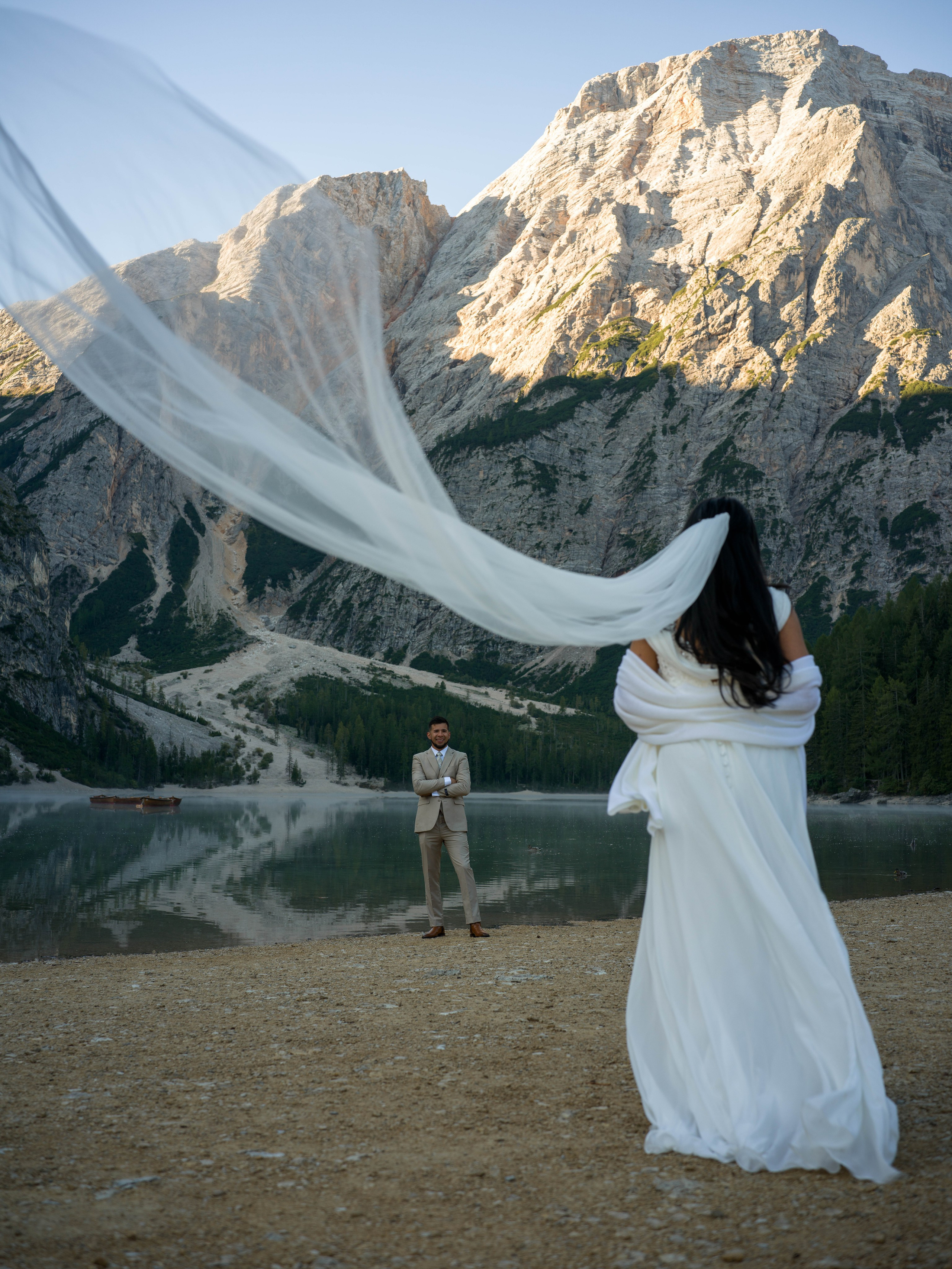 Luxury elopement photography and cinematic video at Lake Braies in the Dolomites with romantic portraits on the boat