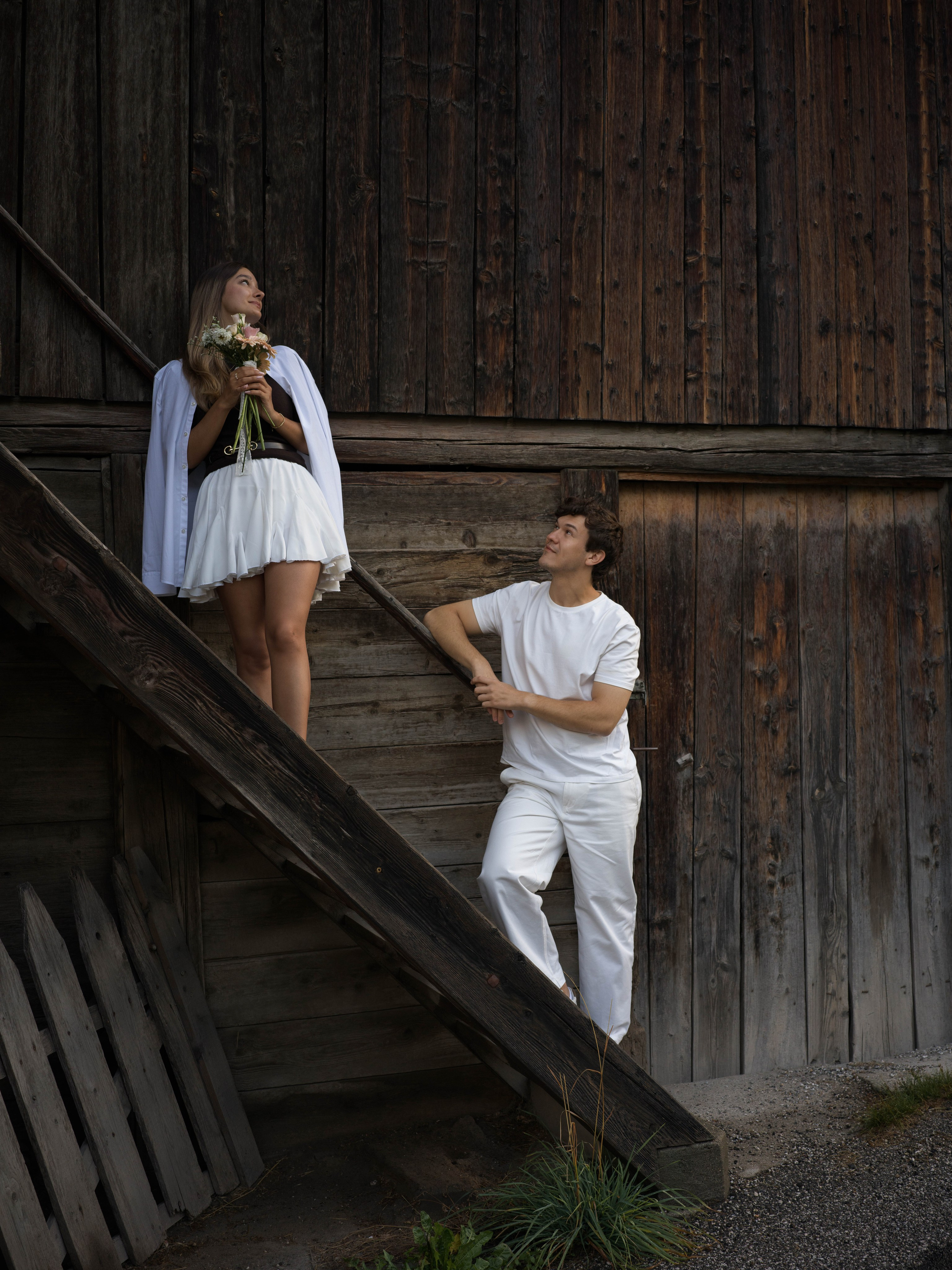 Couple celebrating their engagement after a surprise proposal in Santa Maddalena, Val di Funes, photographed in the Italian Dolomites with panoramic views of the Odle mountains.
