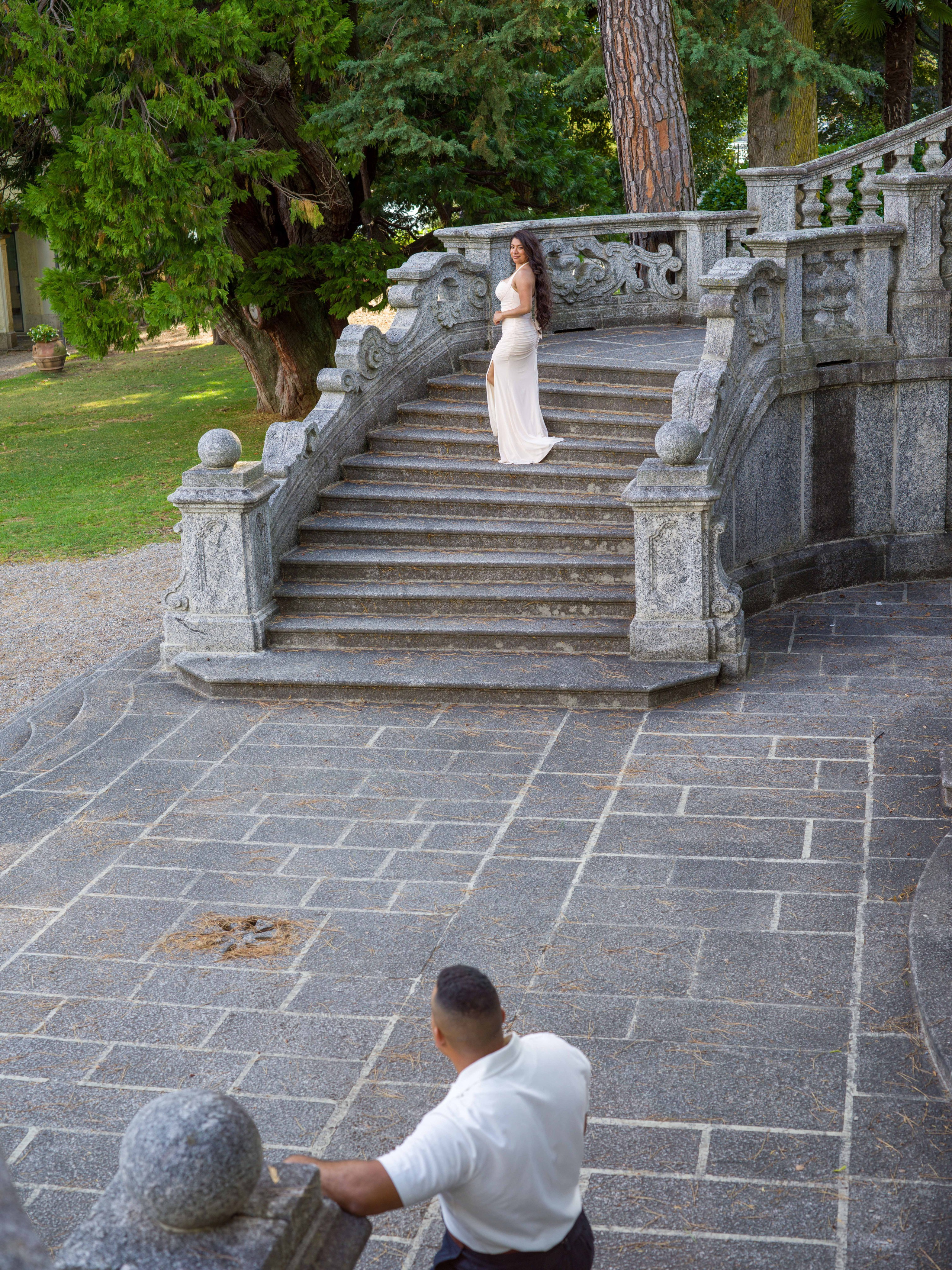 Couple kissing on a park path with Lake Como and the Alps views, Tremezzo elopement photographer