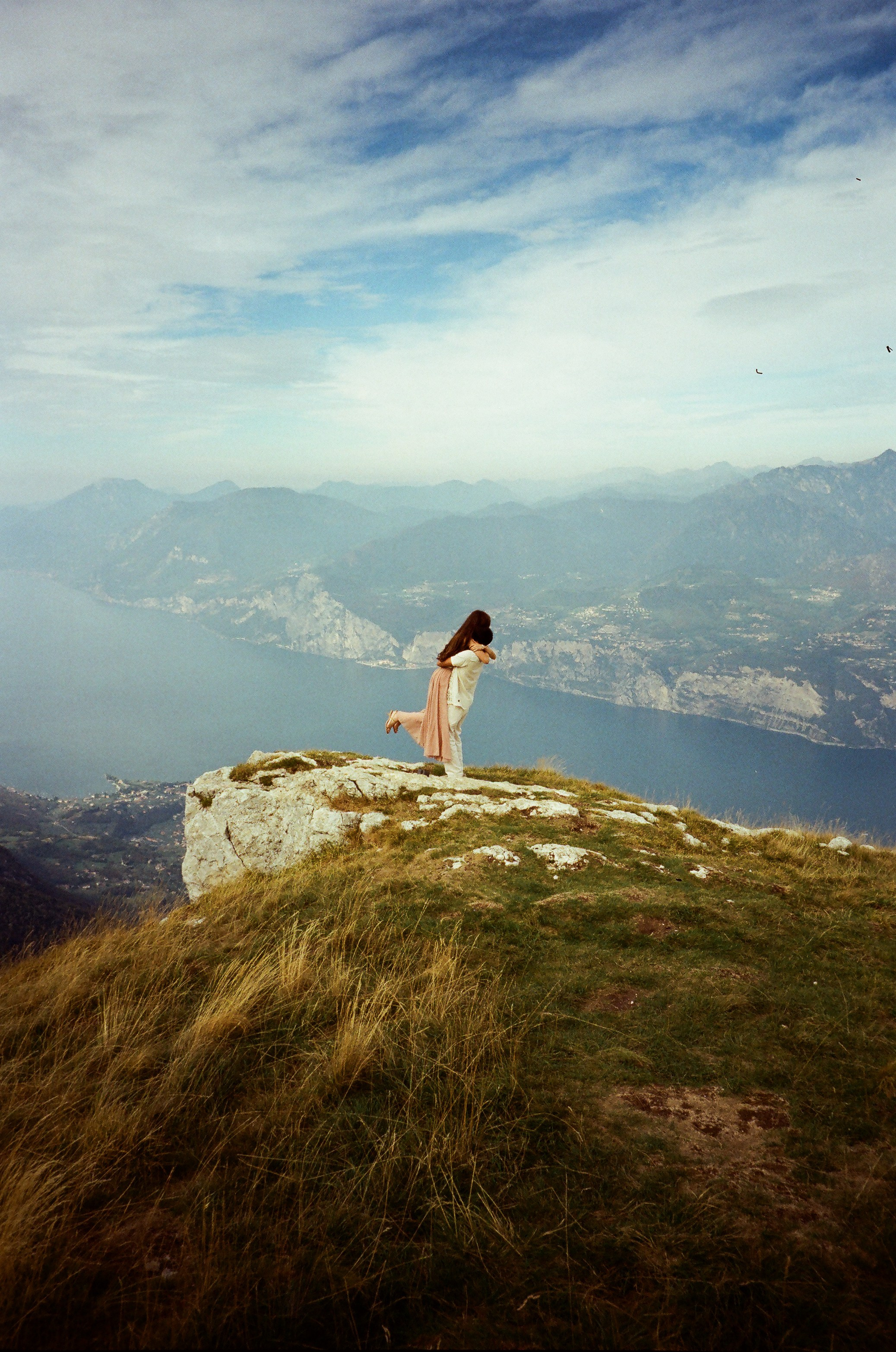 Proposal, Monte Baldo, Lake Garda, Italy – engagement moment captured on film with panoramic view of the lake and mountains