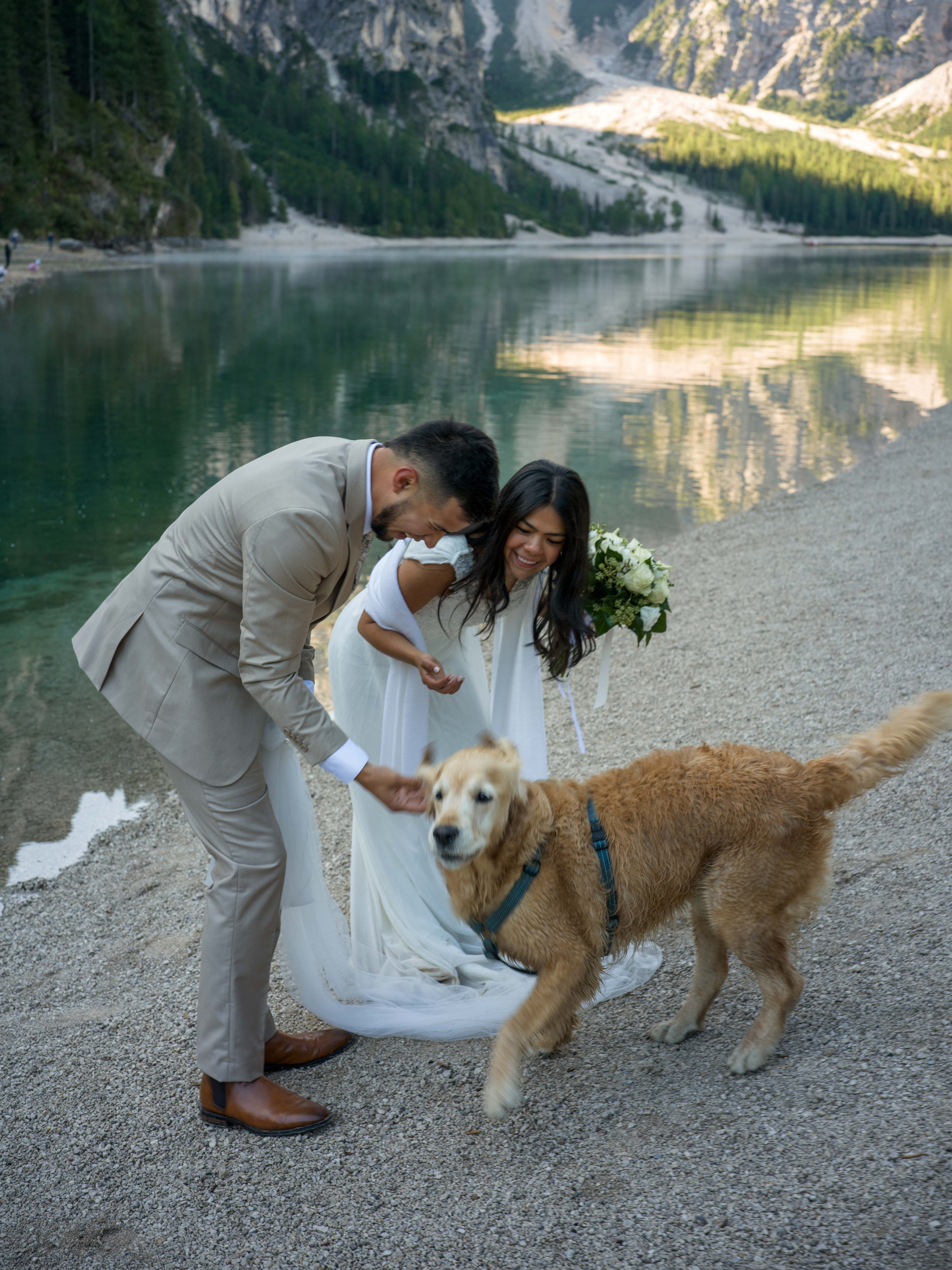 Lake Braies Dolomites wedding elopement photoshoot with couple portraits, wooden boat photography and cinematic mountain scenery
