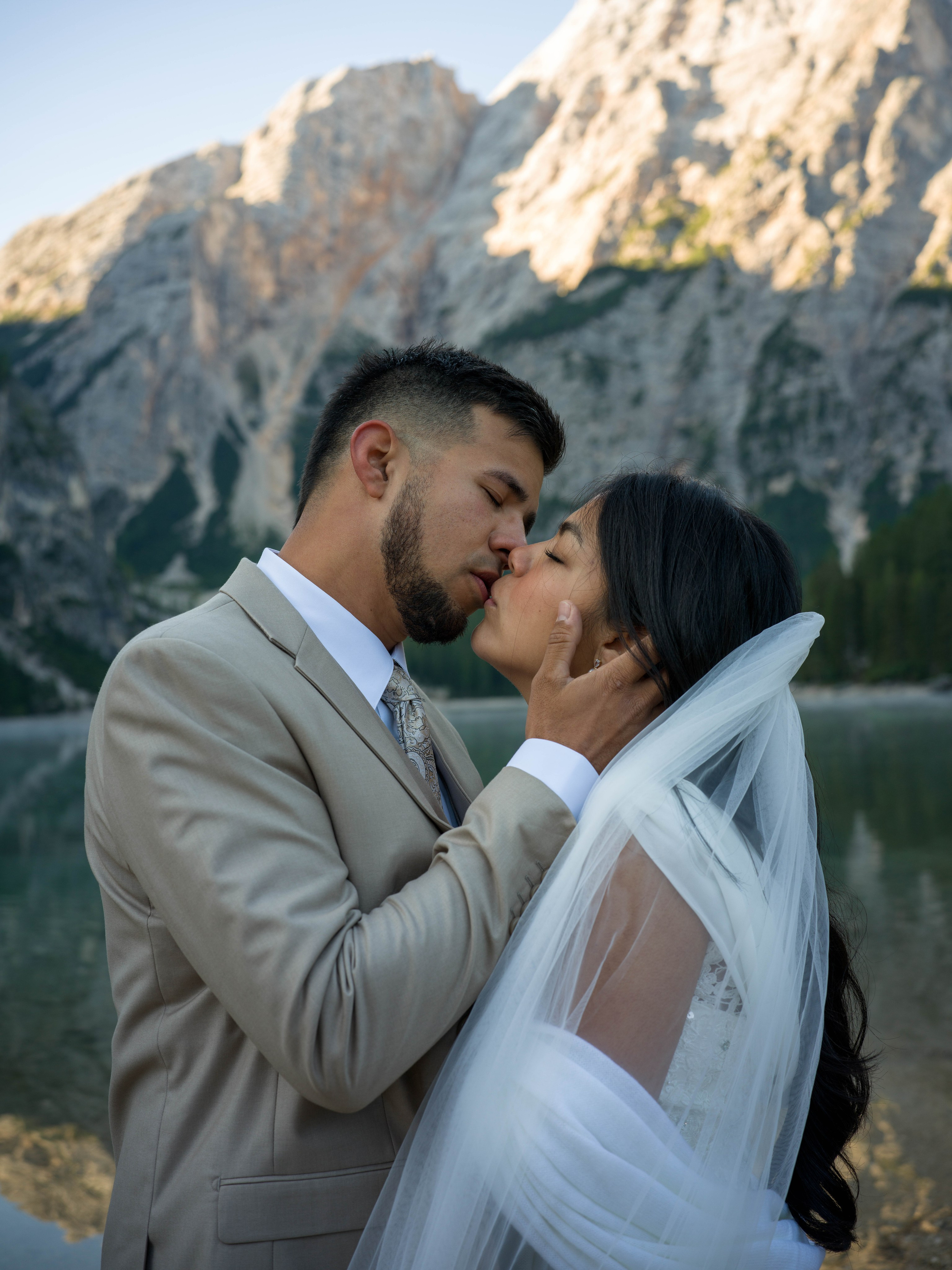Lake Braies Italy elopement photography and cinematic video with a couple exploring the lake, boat and Dolomites landscape