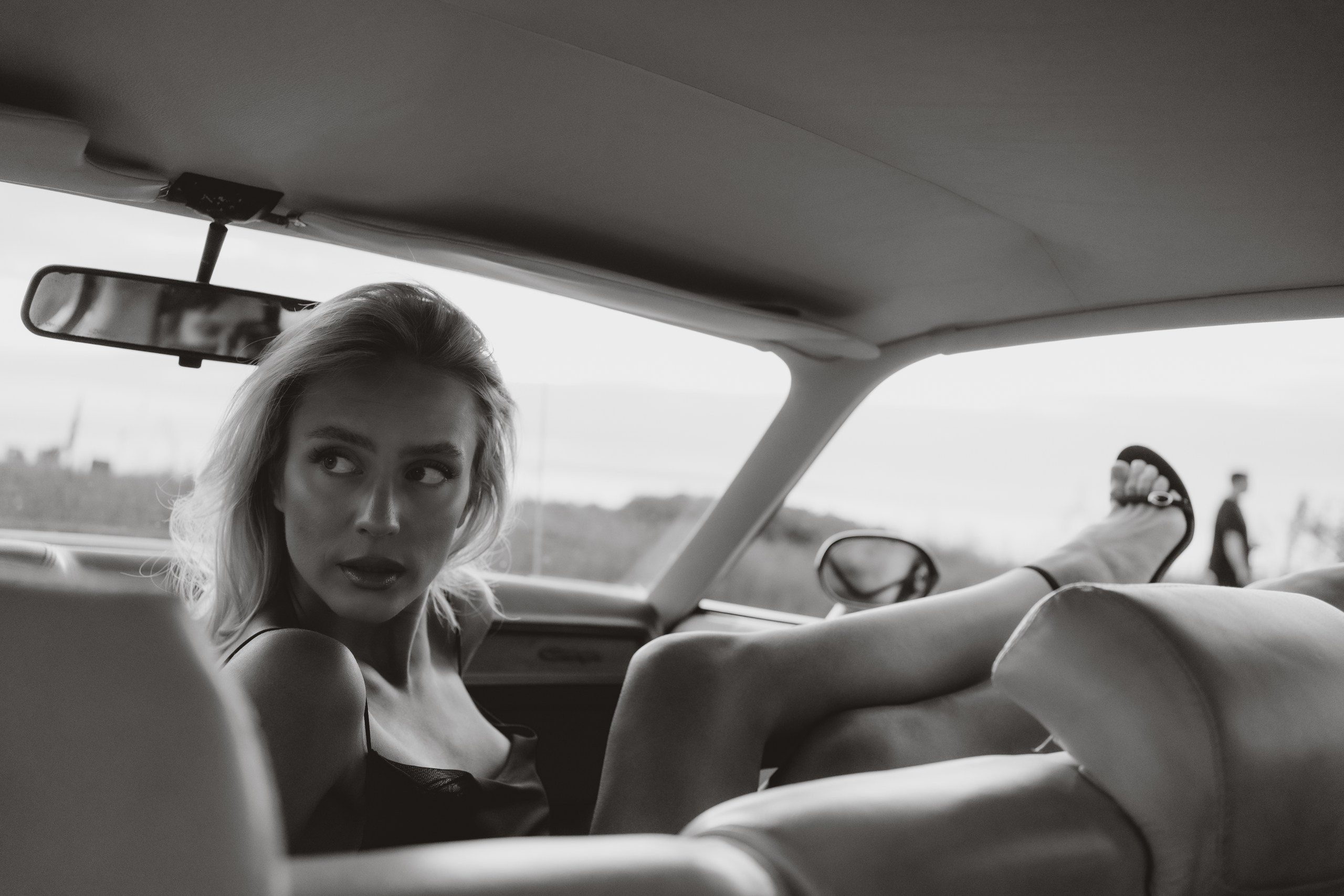 Portrait of Agne Vaher inside a vintage car, photographed by Anna Chekryshova