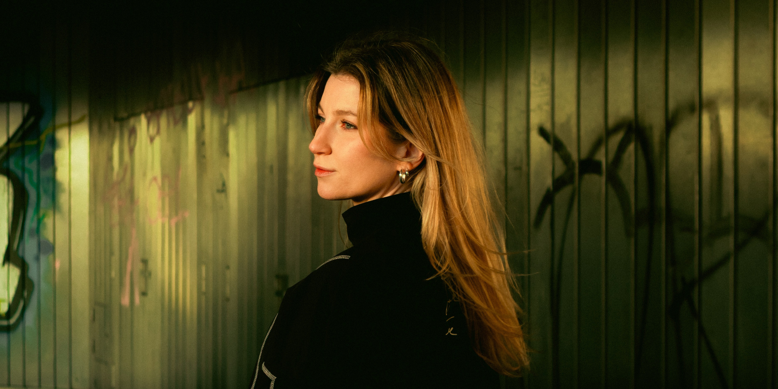 Female portrait in a Berlin urban passage framed by modern architectural structures