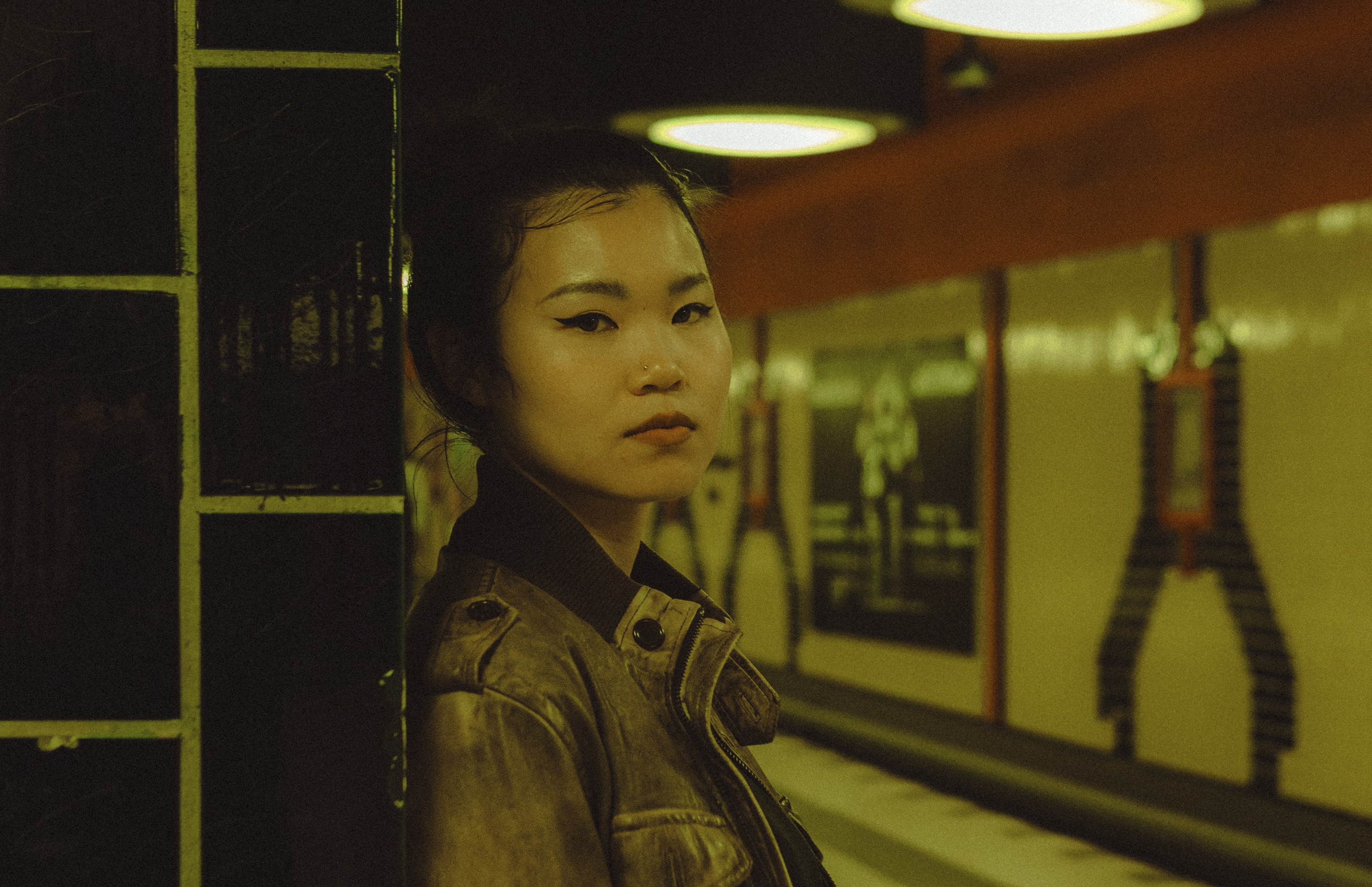 Woman standing beside a tiled column at a Berlin U-Bahn platform