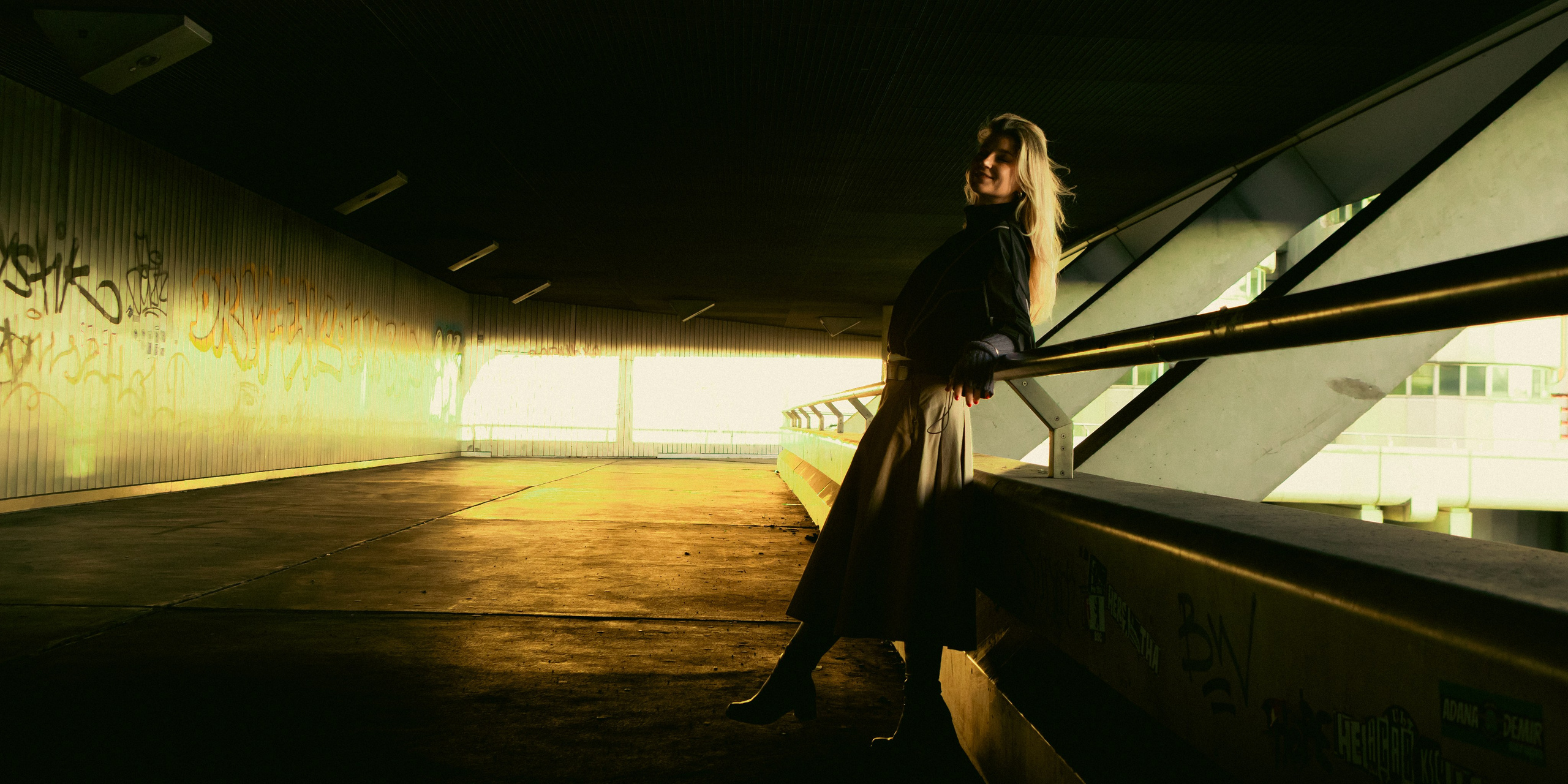 Female portrait in a Berlin urban underpass with geometric architecture and dramatic light