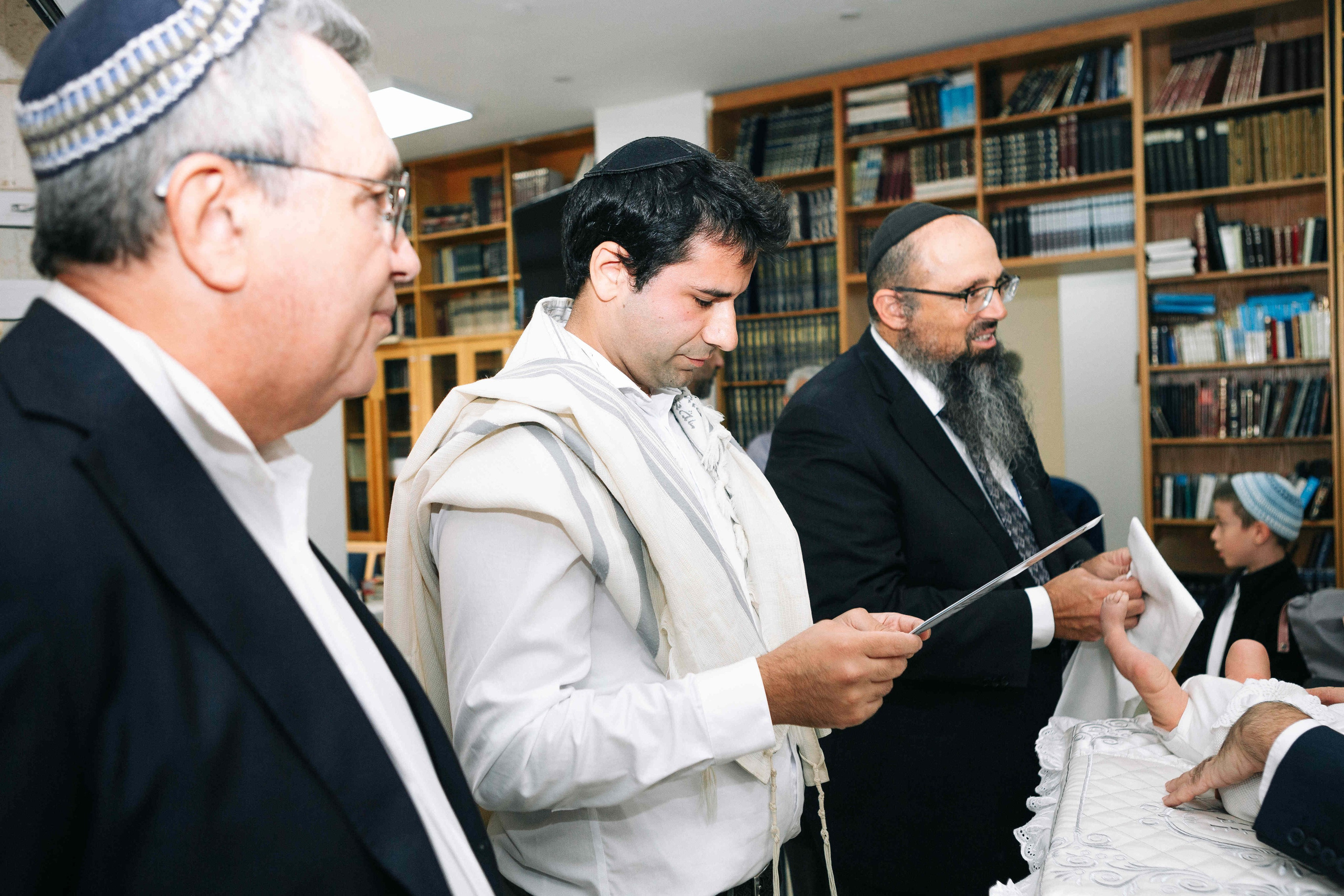BRITH MILA IN THE SMALL SYNAGOGUE. PHOTOGRAPHER IN ISRAEL