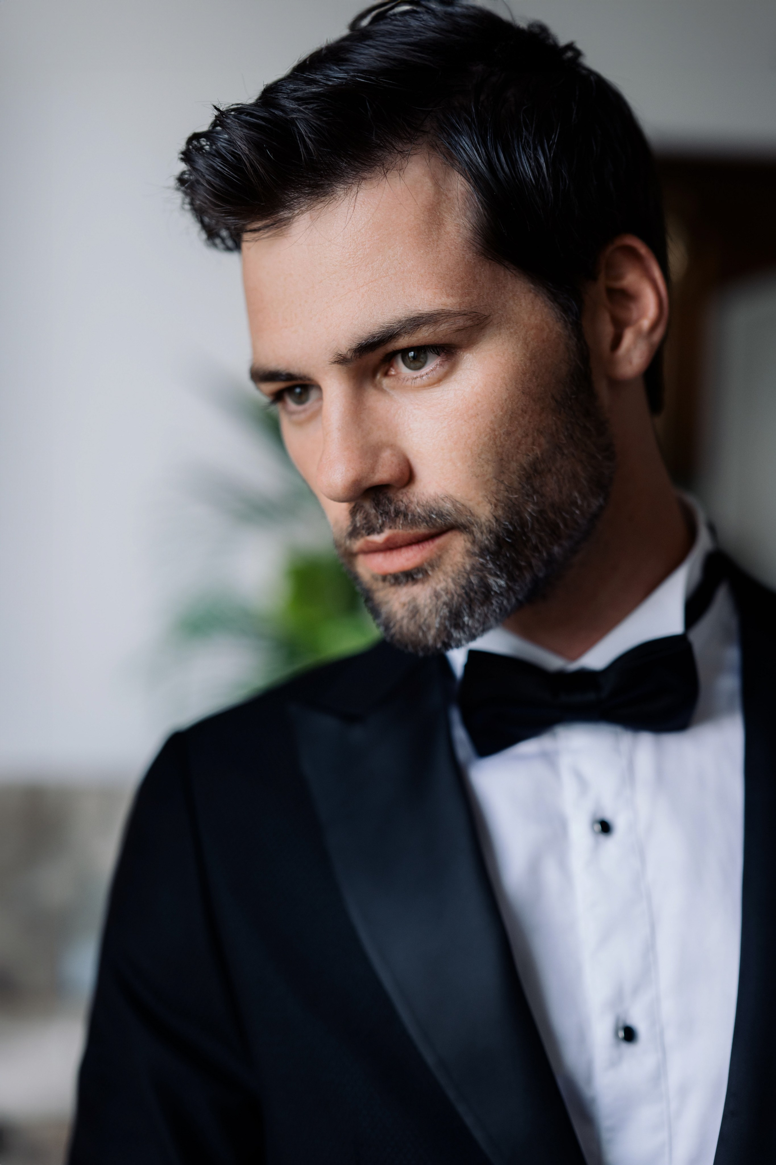 a man in a tuxed suit and bow tie