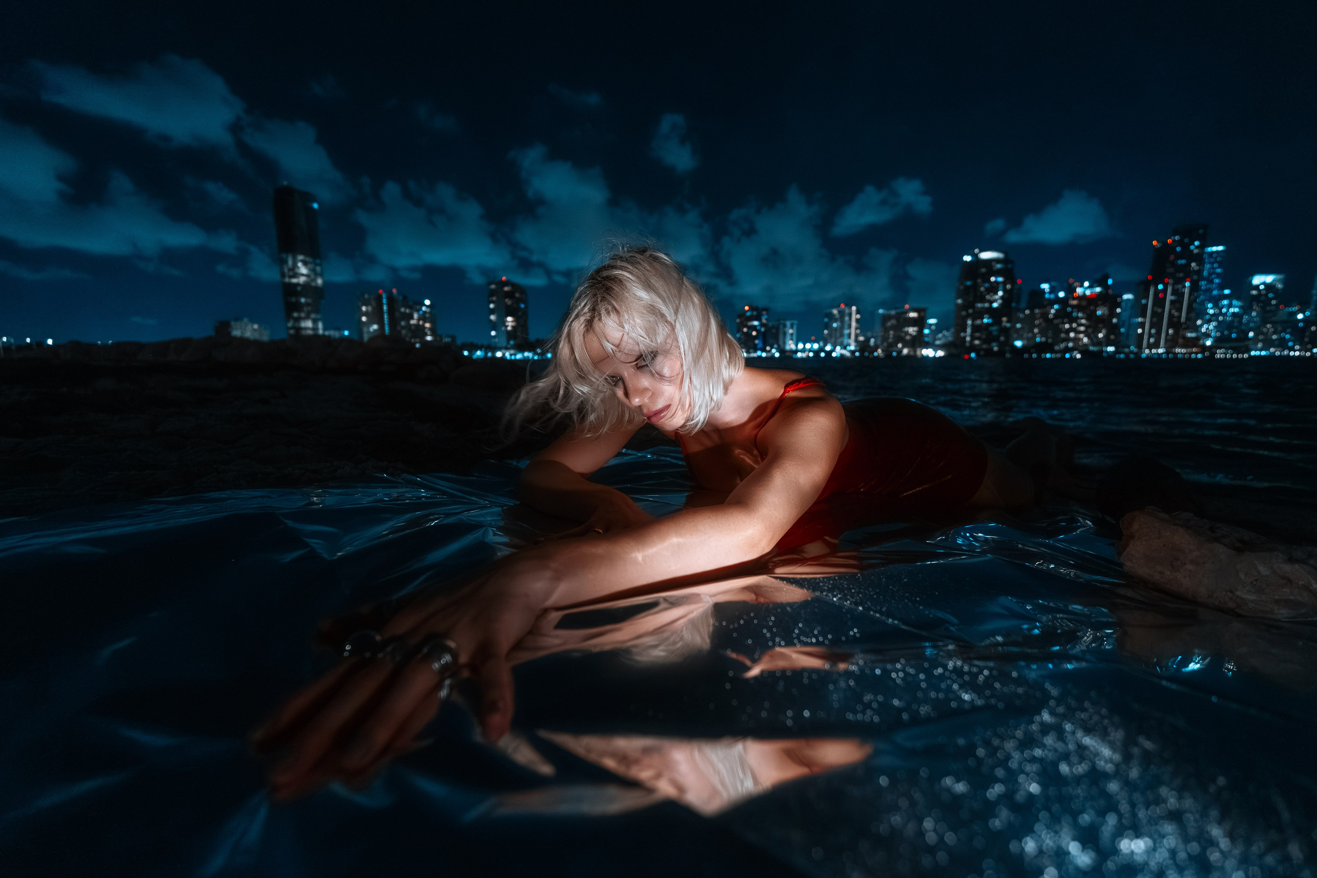 he red dress and water form a clean compositional duality.