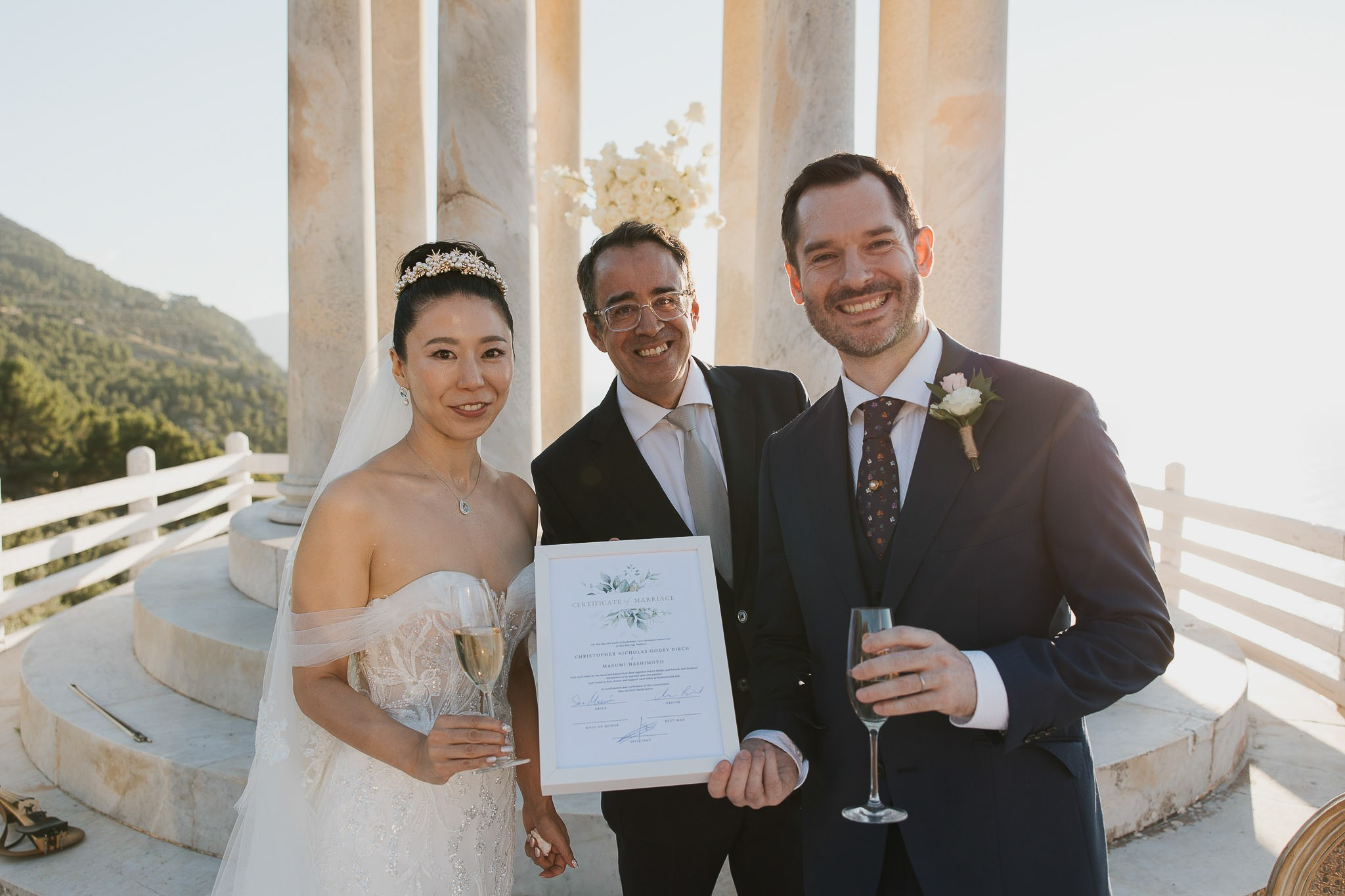 Newlyweds holding marriage certificate Son Marroig