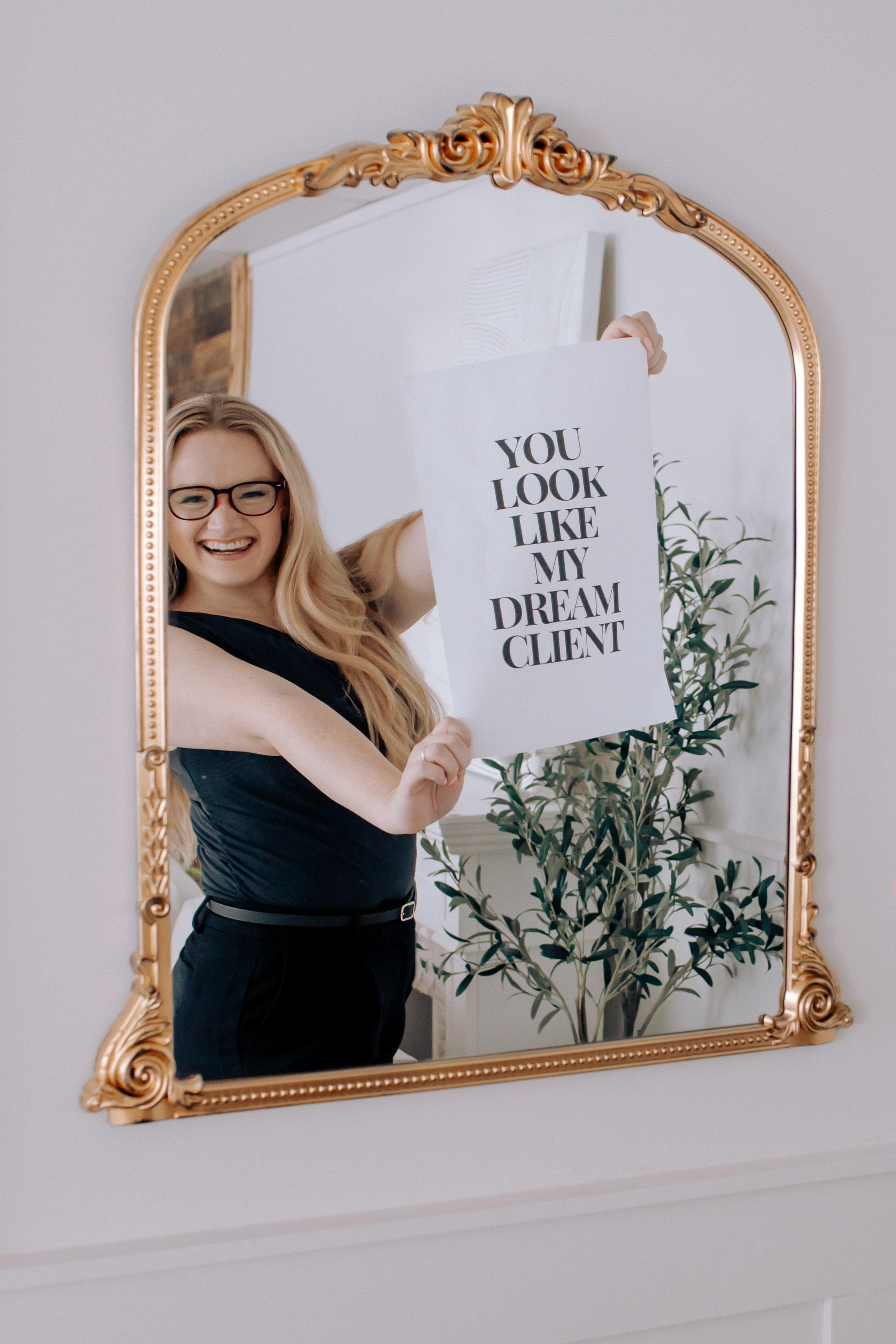 Hair Stylist holding a sign to attract her dream client