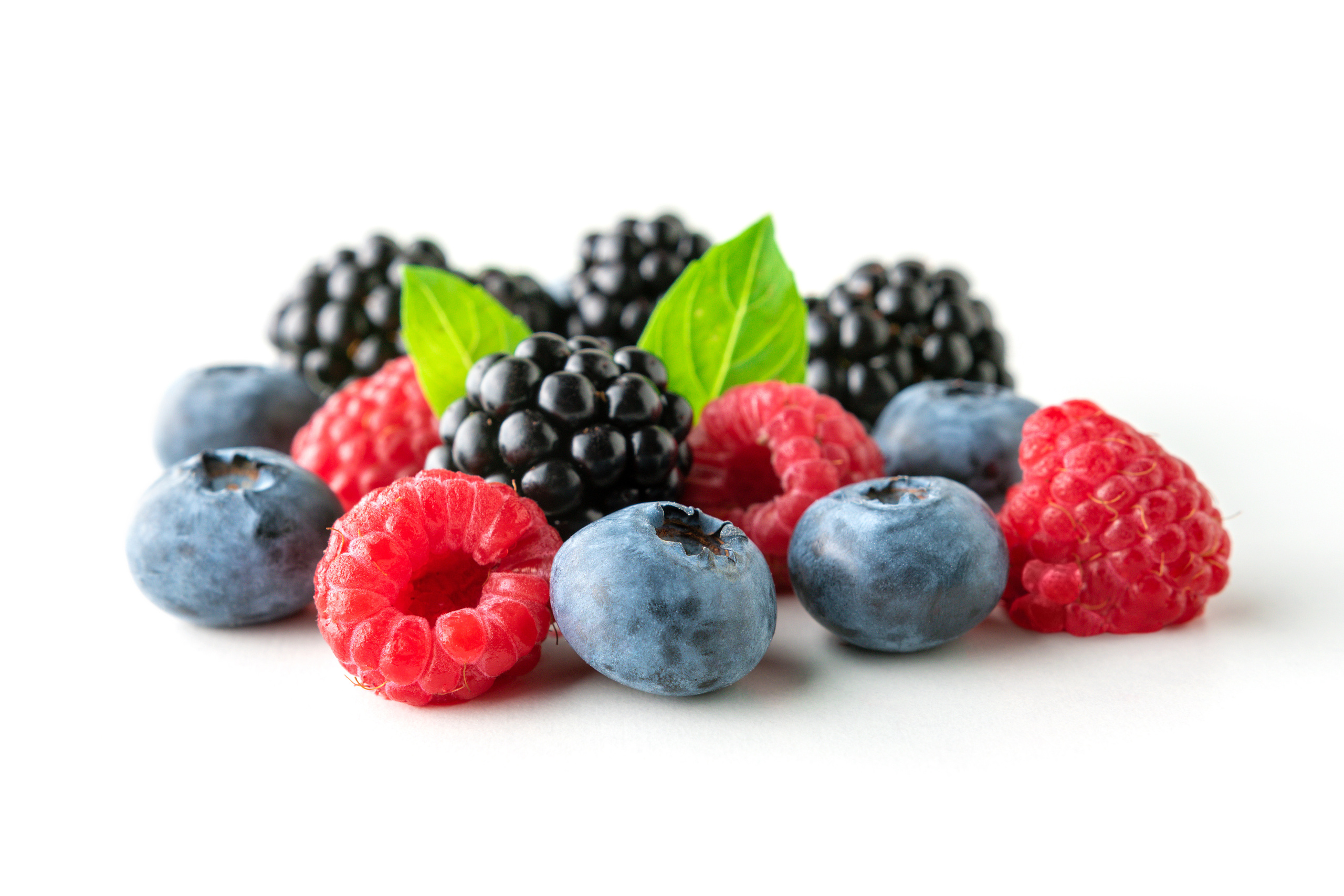 Sweet berries mix isolated on white background. Ripe raspberry, blueberry and blackberry.