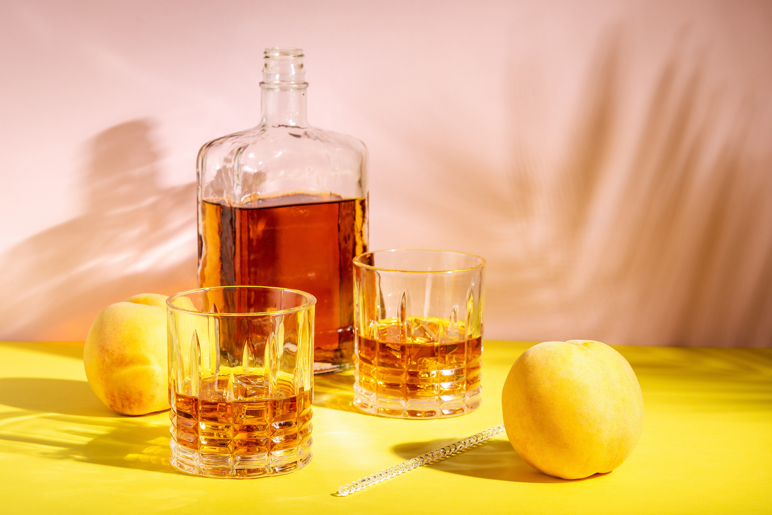 Rum or Amaretto sour with ice in a glass on a bright background.